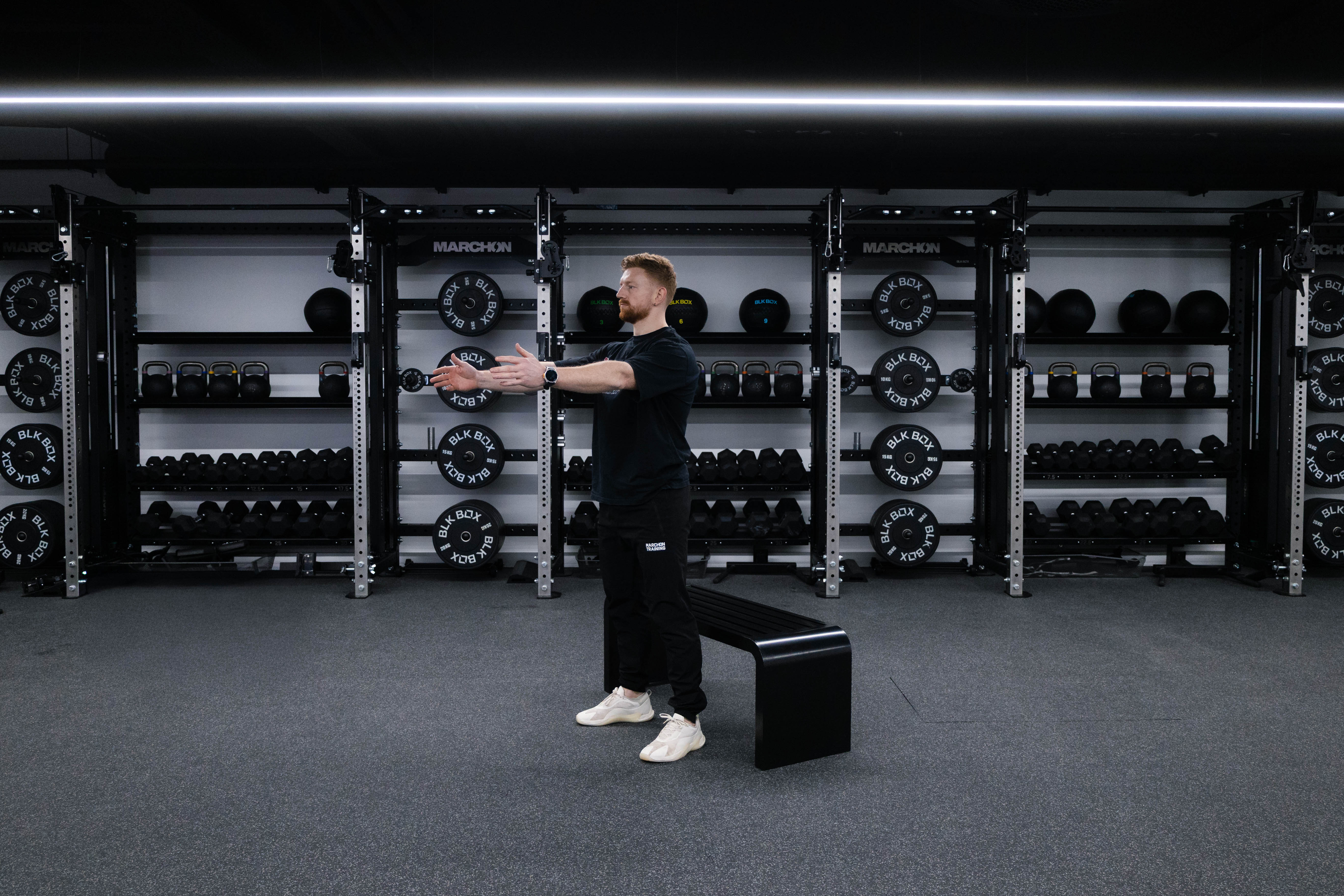 Marchon coach Patrick James demonstrates how to perform a squat to box