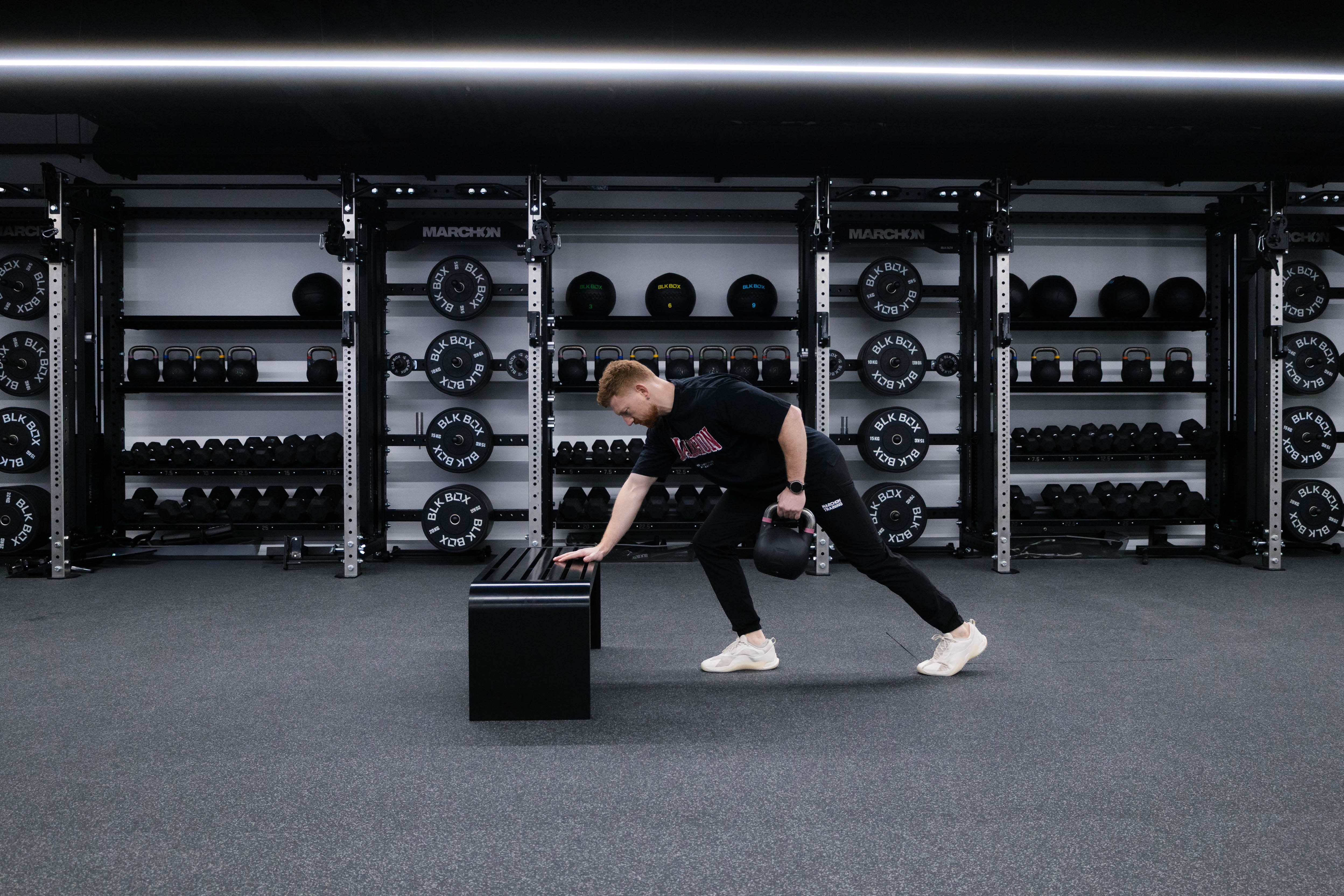 Marchon coach Patrick James demonstrating how to perform a single-arm row with a kettlebell