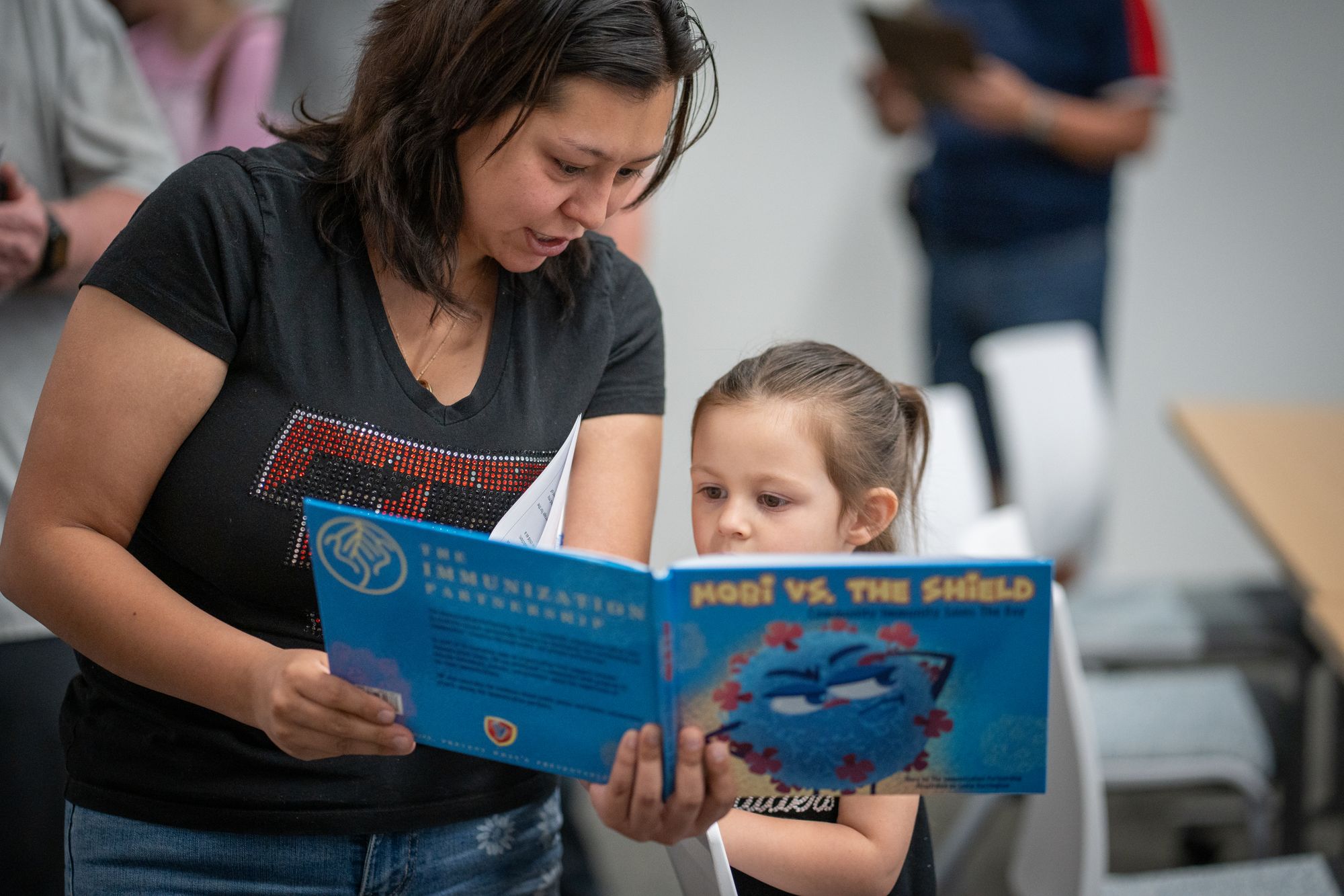 A mother and daughter read together at a vaccine clinic in West Texas last year. Cases in South Carolina have since exceeded those reported in the Lone Star State’s outbreak