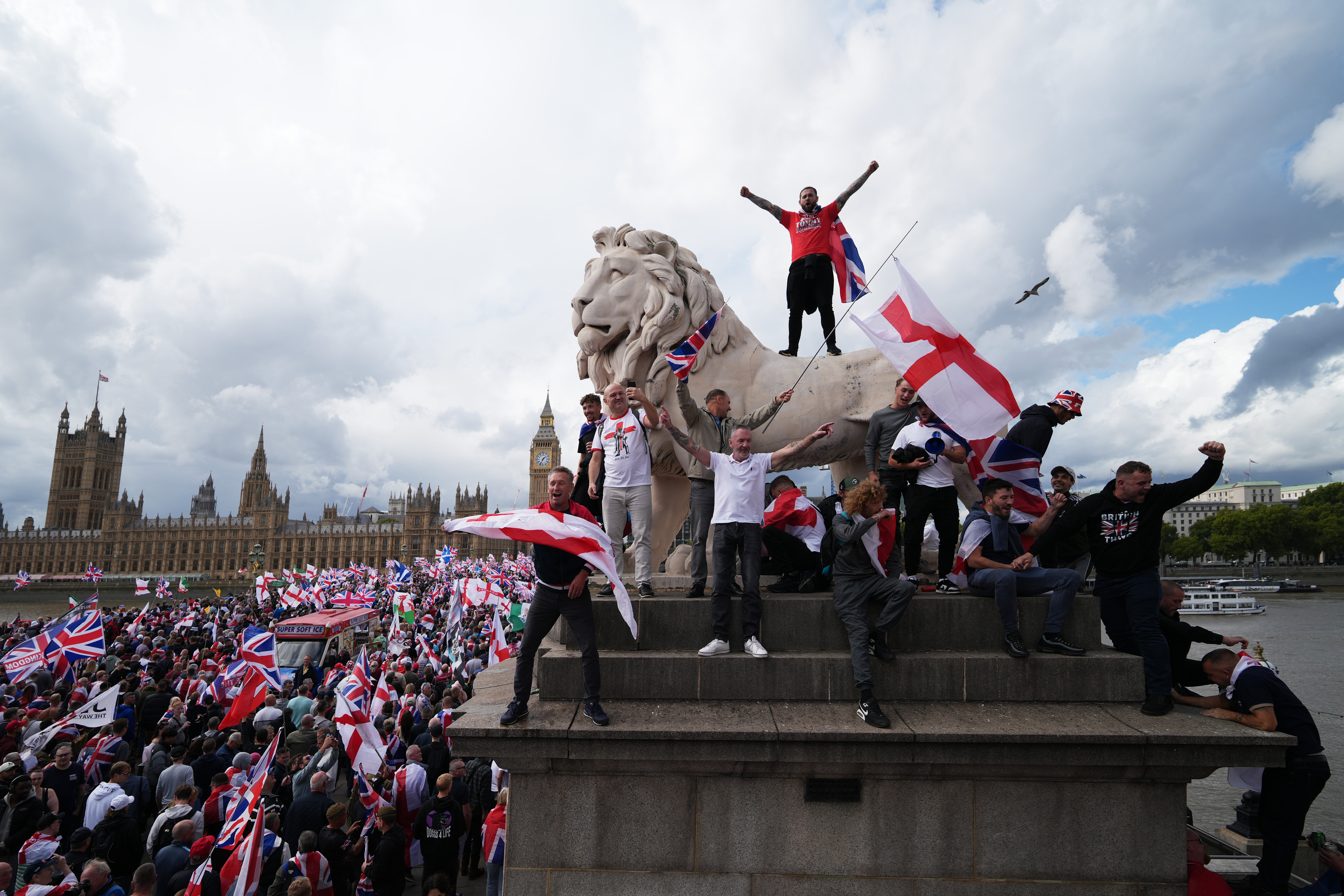 Protesters wave Union Jack and St George's England flags during the 