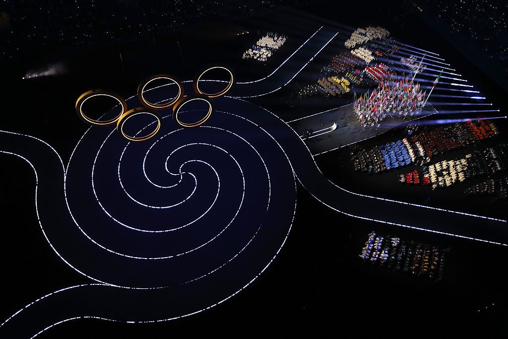 The five Olympic rings are raised inside San Siro