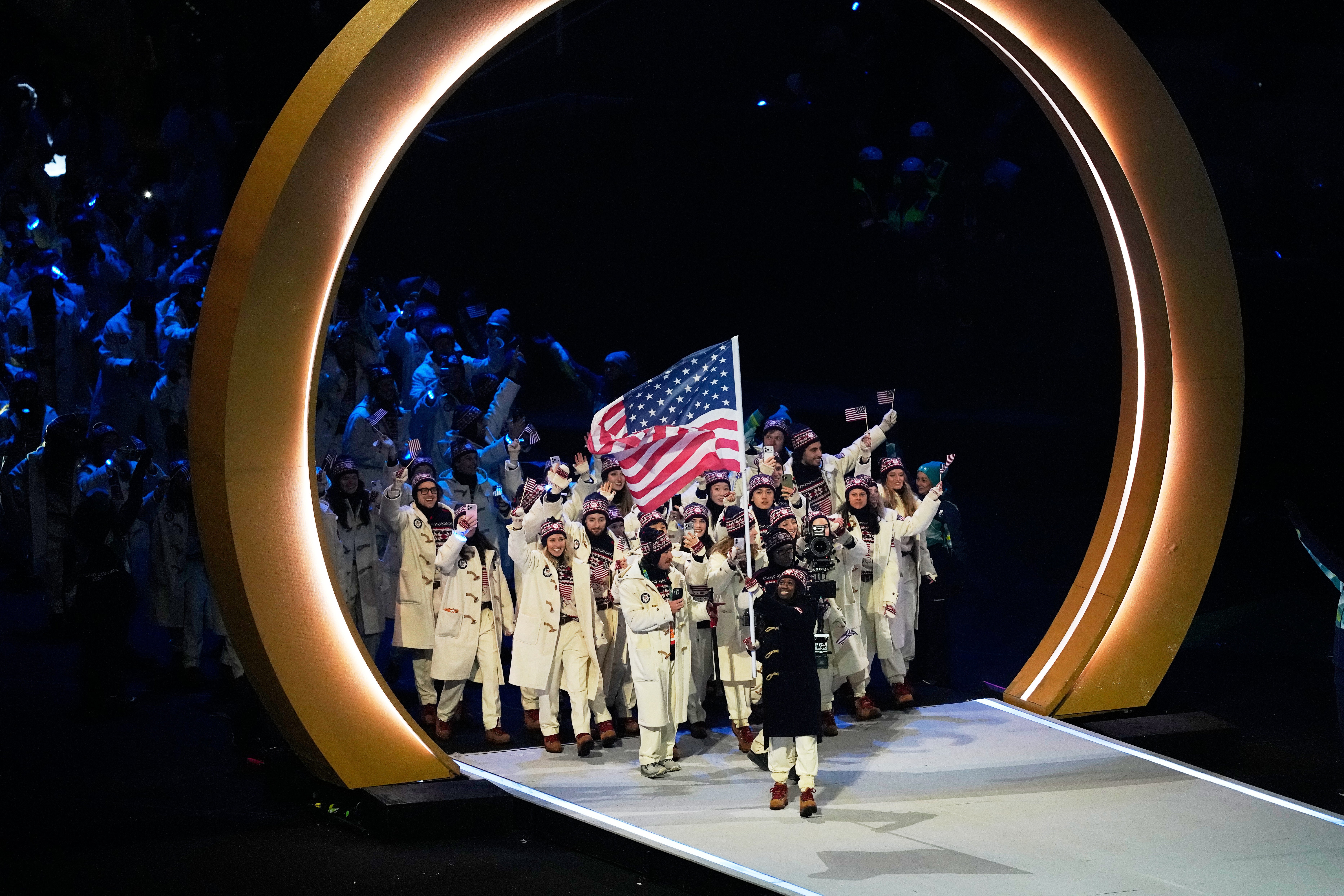 Team USA, led by speedskater and flag bearer Erin Jackson, was among the final delegations to parade into Milan’s San Siro stadium on Friday.