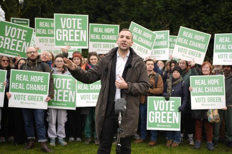 <p>Green Party leader Zack Polanski speaking to party volunteers at Granada Park in Denton</p>