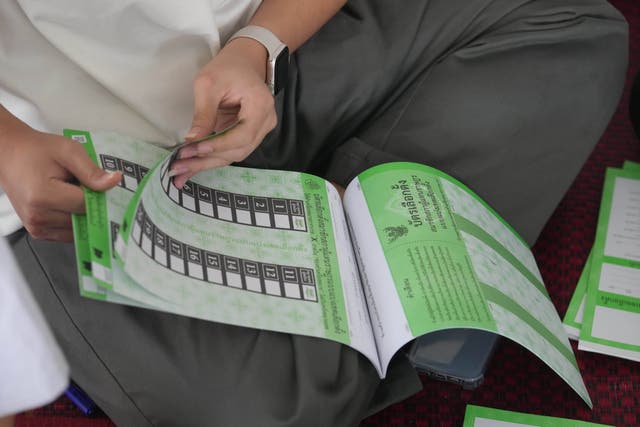 <p>A volunteer checks ballots for Sunday's general election in Bangkok, Thailand, Saturday, 7 Feb 2026</p>