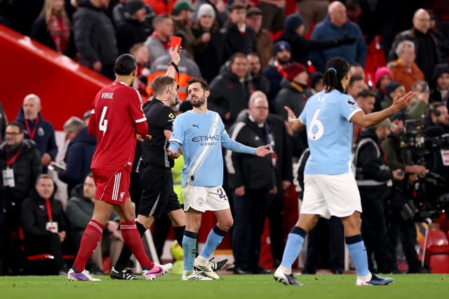 <p>Referee, Craig Pawson shows a red card to Dominik Szoboszlai of Liverpool (not pictured) during the Premier League match between Liverpool and Manchester City </p>