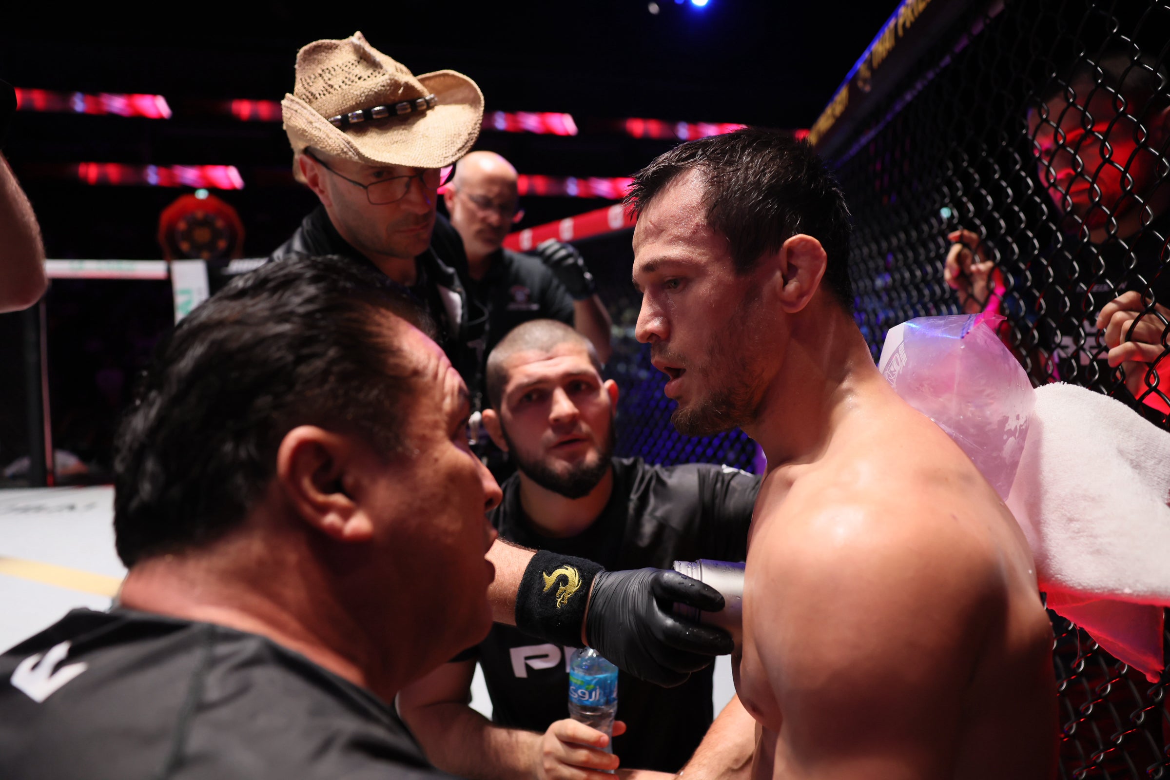Usman Nurmagomedov (right) with cousin Khabib (centre) in his corner