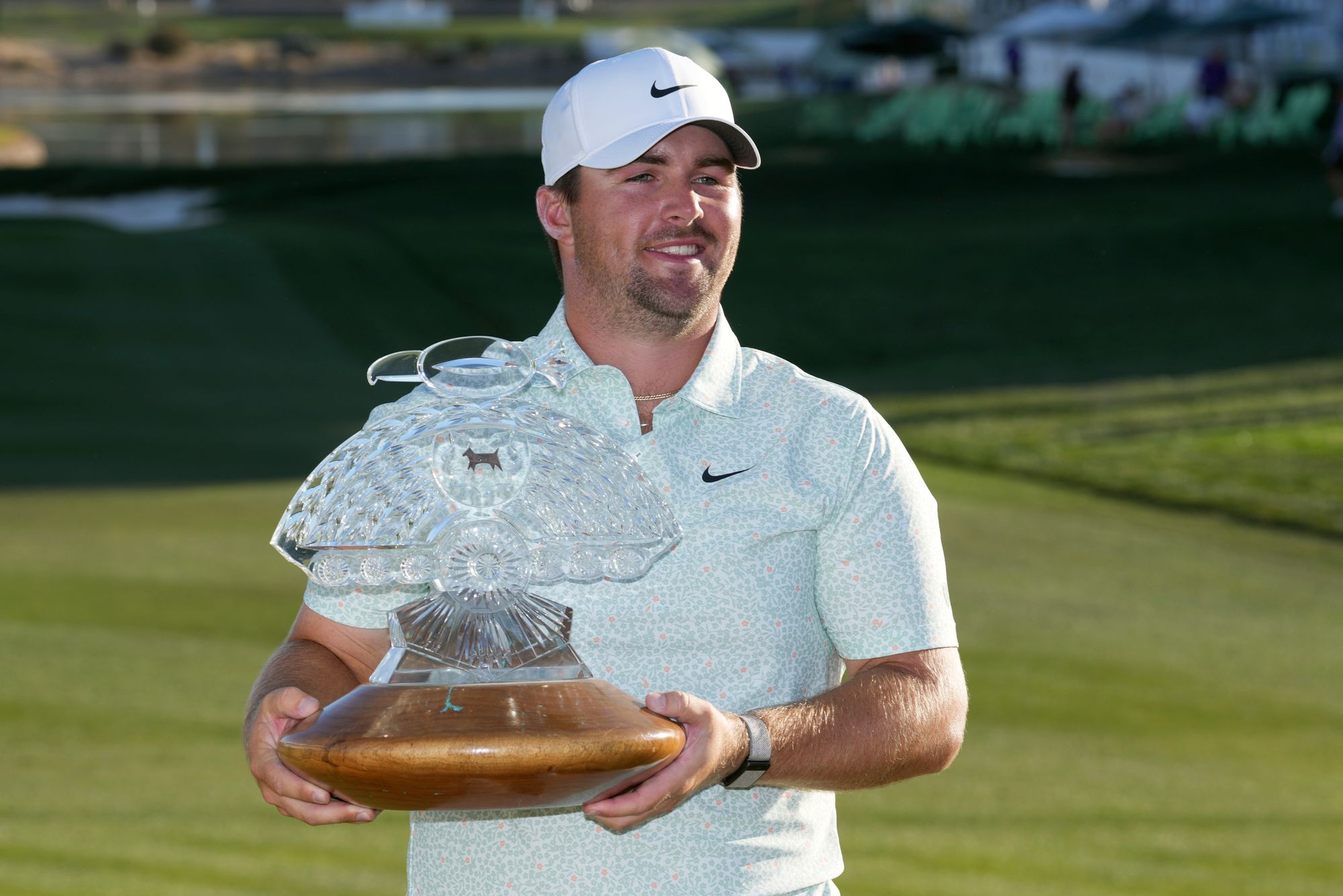 Chris Gotterup smiles as he holds up the winner's trophy after defeating Hideki Matsuyama in a one hole playoff