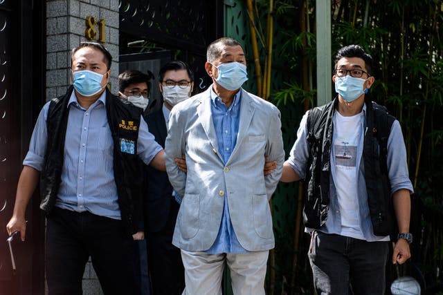 <p>File image from August 2010: Police lead Hong kong pro-democracy media mogul Jimmy Lai (C) away from his home after he was arrested under the new national security law</p>