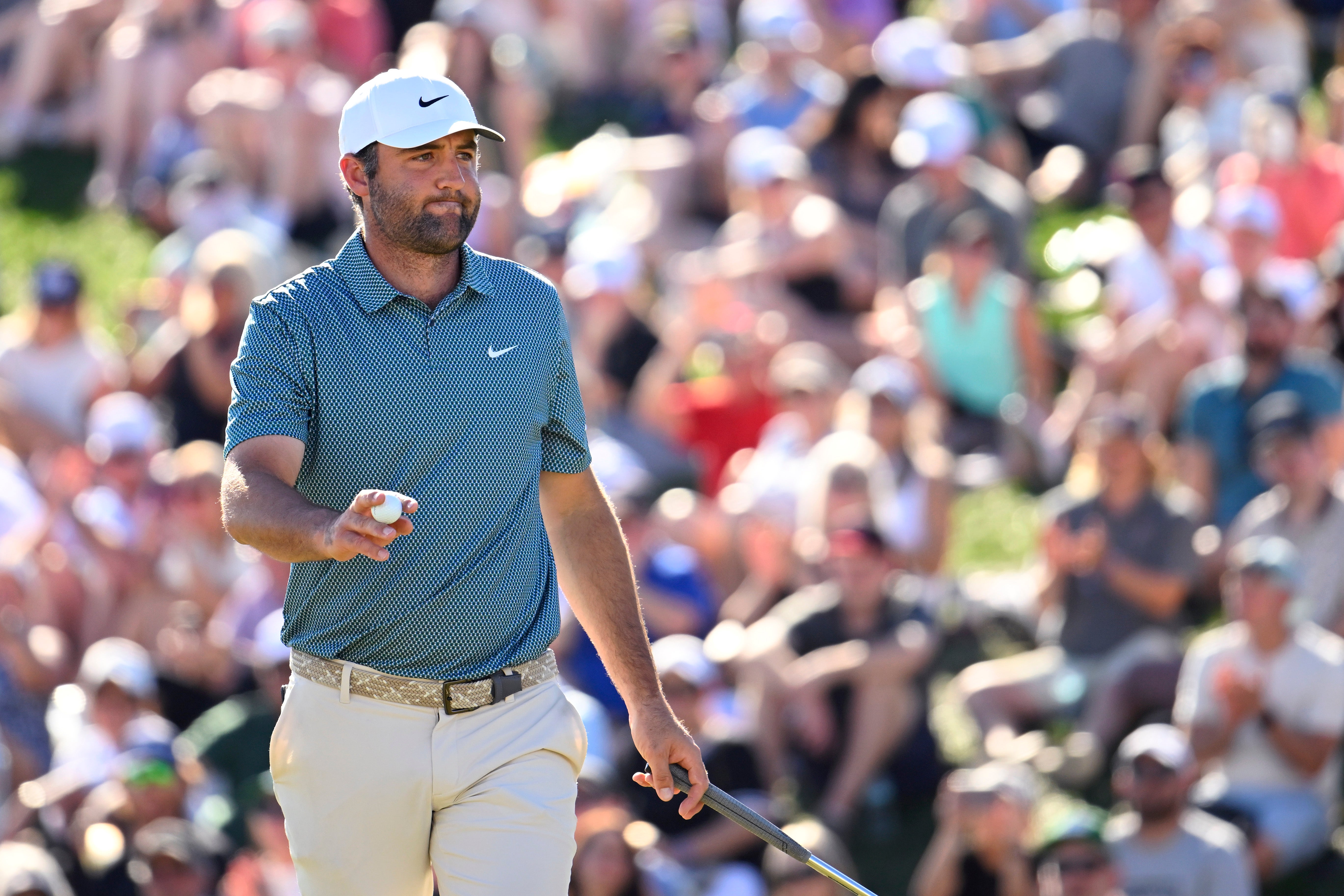 Scottie Scheffler of the United States acknowledges the crowd on the 18th green