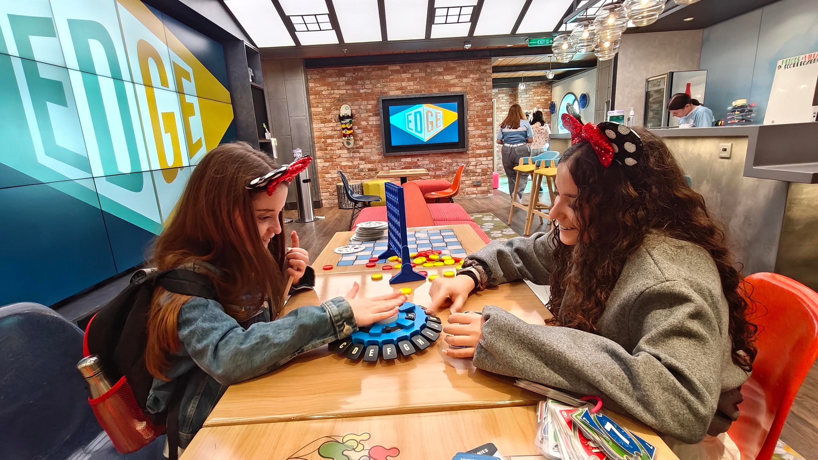 Amelie and Isabelle Shoffman enjoying the Edge tween hangout aboard Disney Wish