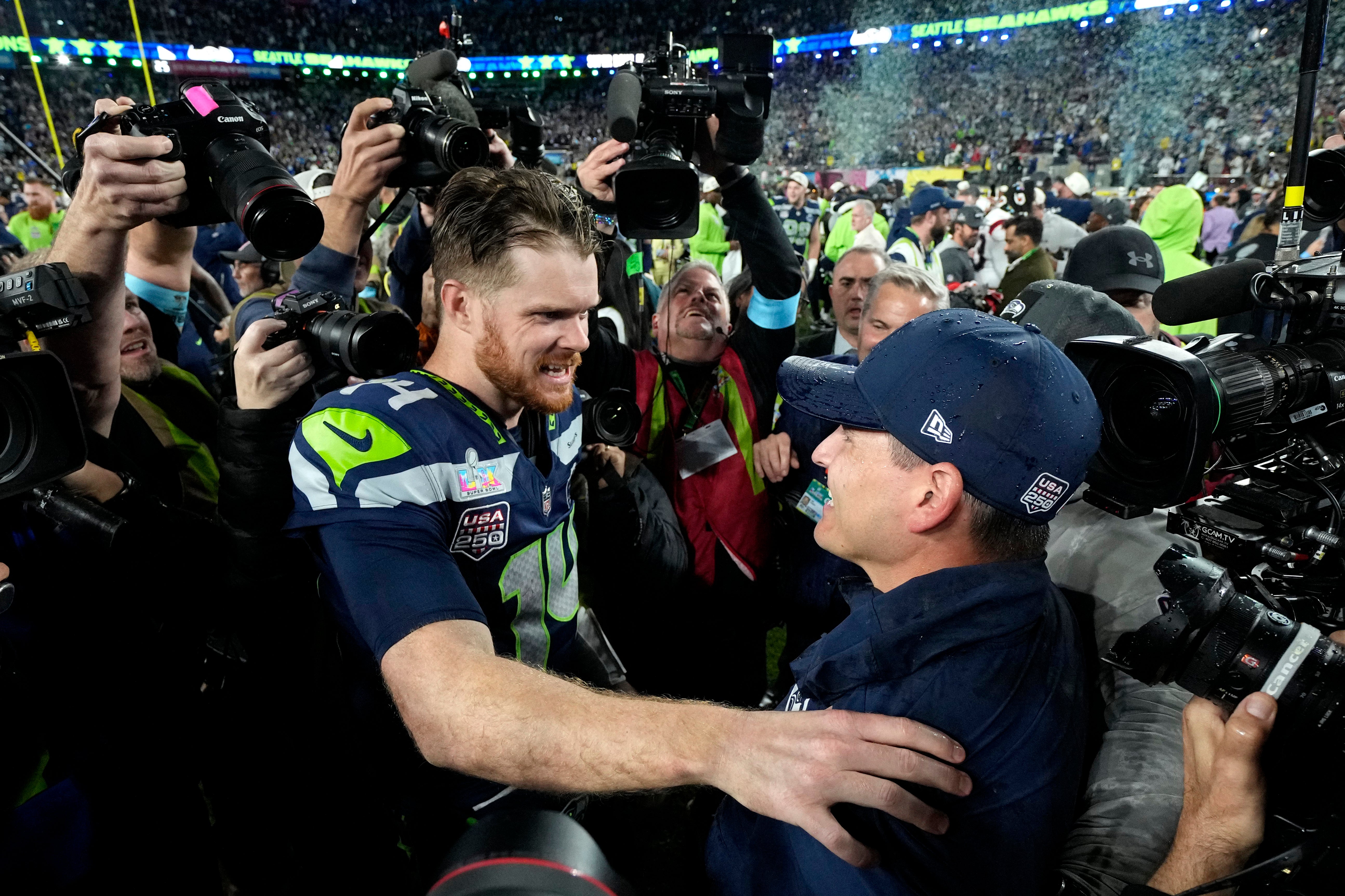 Seattle Seahawks head coach Mike MacDonald celebrates with quarterback Sam Darnold