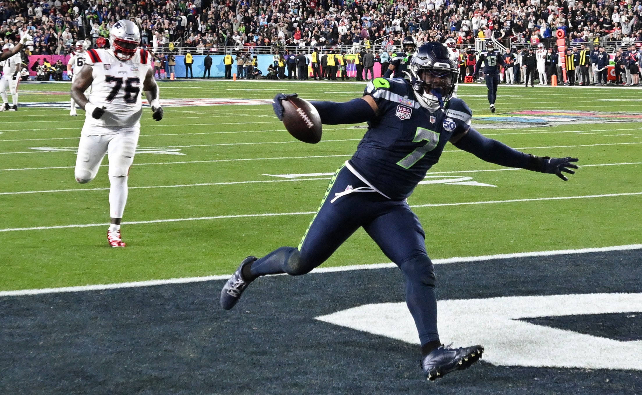 Uchenna Nwosu scores a touchdown during Super Bowl LX