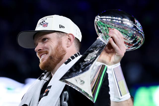 <p>Sam Darnold #14 of the Seattle Seahawks celebrates with the Vince Lombardi Trophy</p>