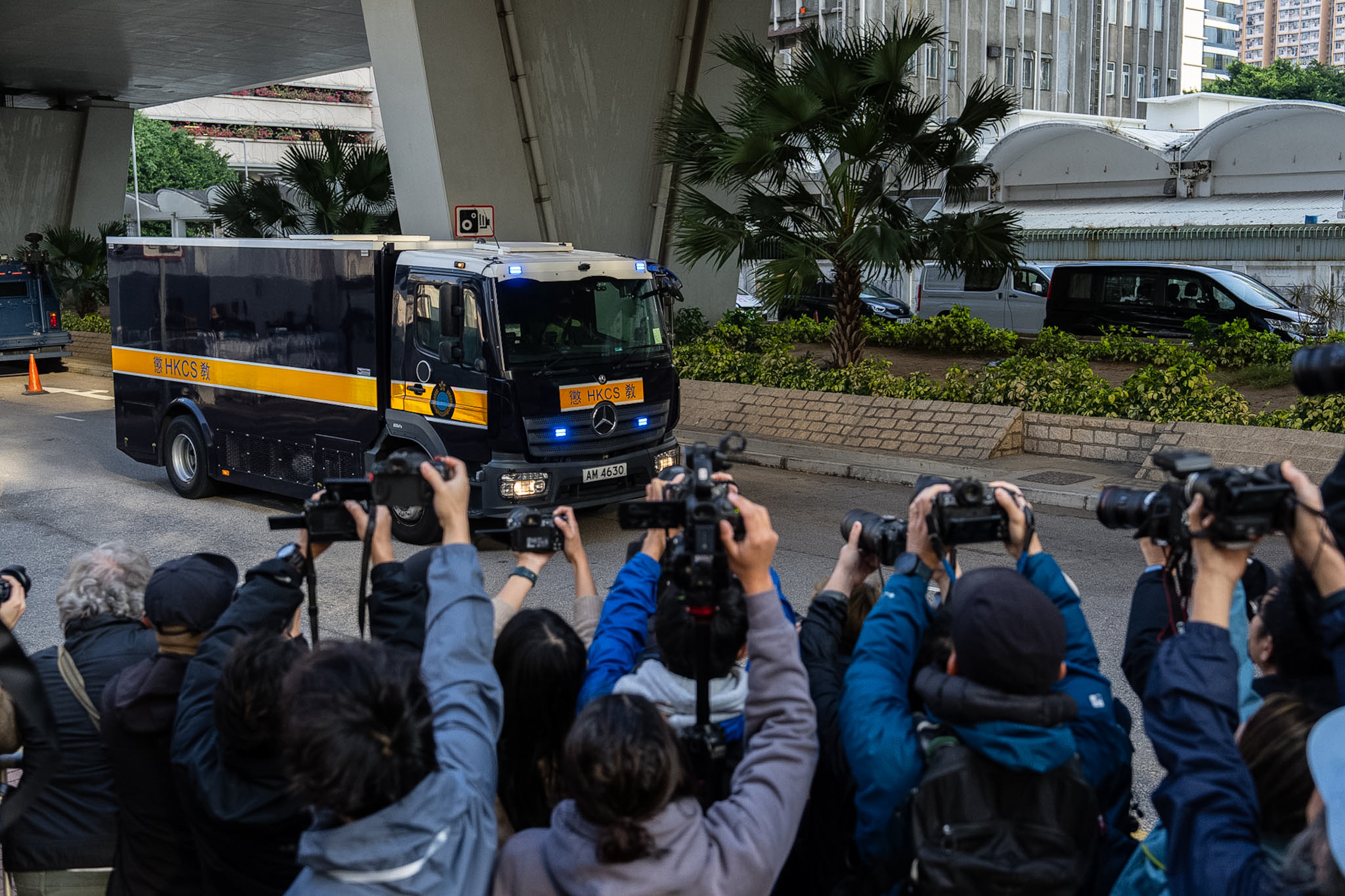 A Correctional Services Department vehicle believed to be carrying Hong Kong activist publisher Jimmy Lai, arrives at the West Kowloon Magistrates' Courts ahead of his sentencing in Hong Kong
