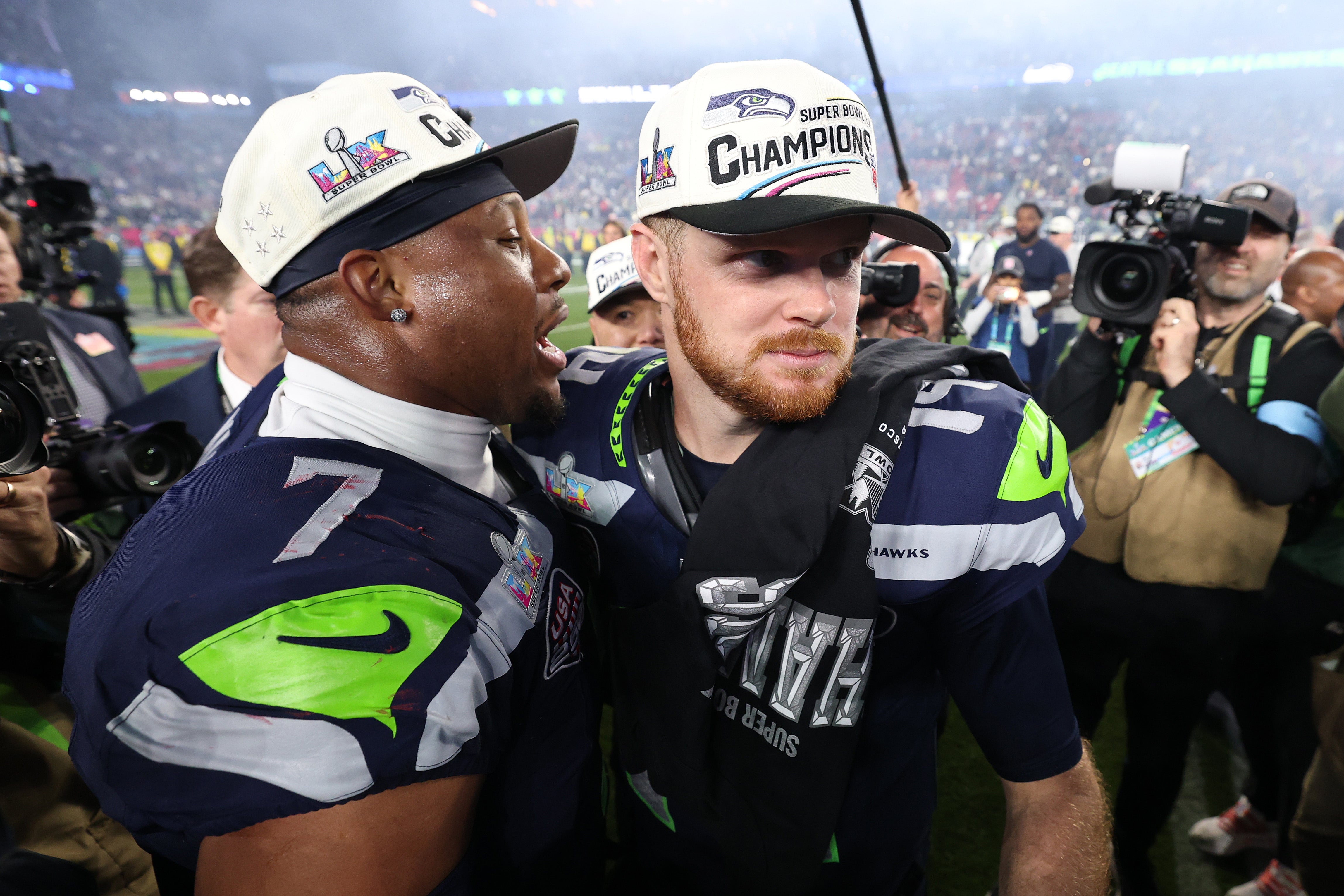Sam Darnold and Uchenna Nwosu of the Seattle Seahawks celebrate