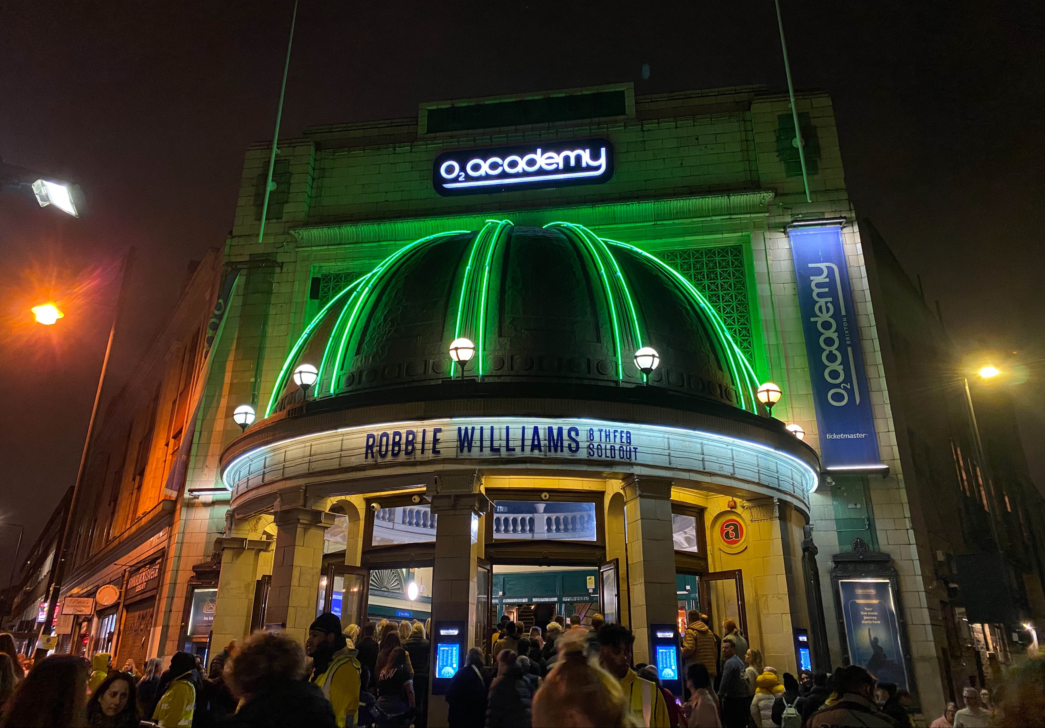 People queue at O2 Academy Brixton in London for Robbie Williams' 'The Long 90's' tour gig