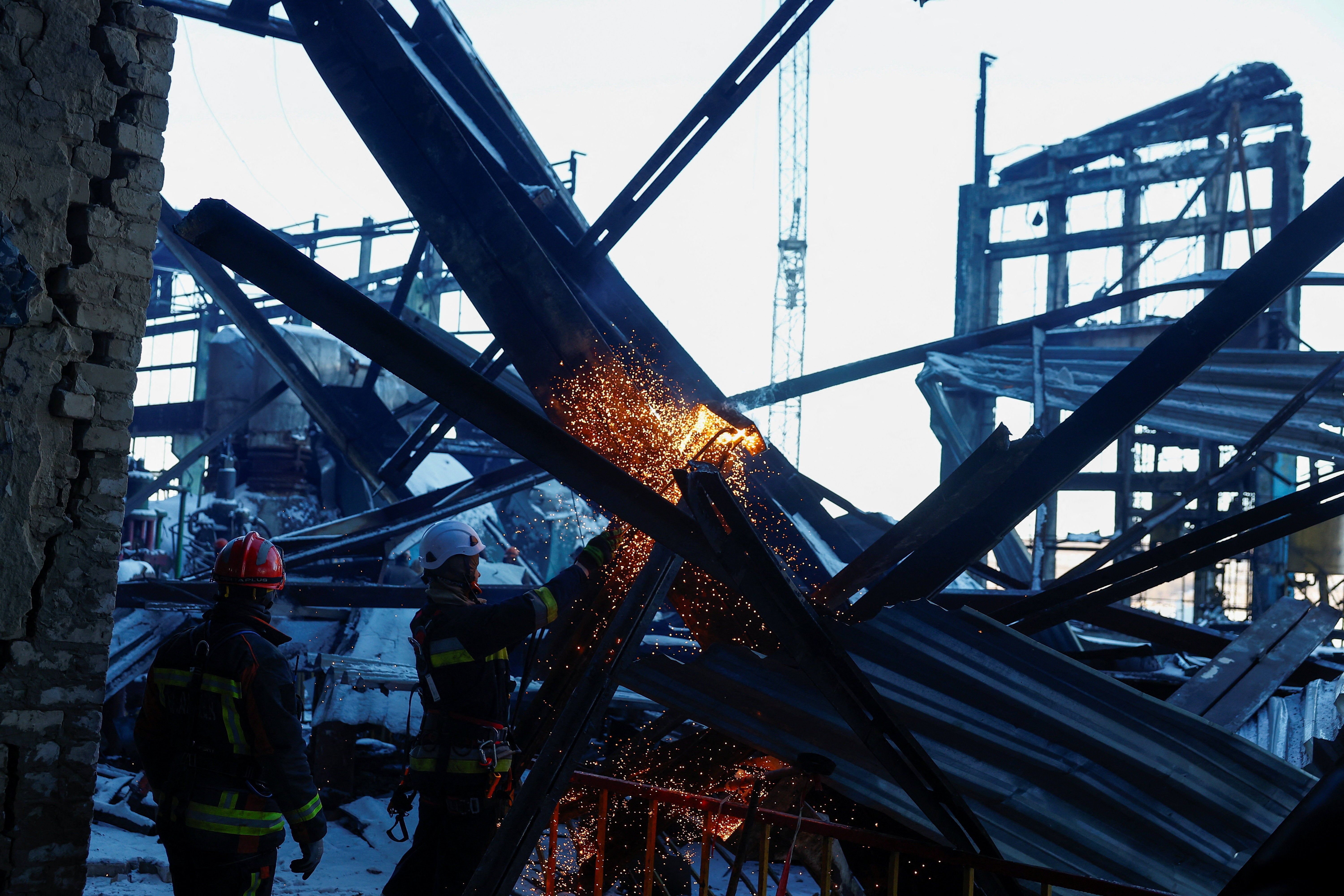 Rescuers remove debris at a thermal power plant damaged by Russian missile strikes in Ukraine