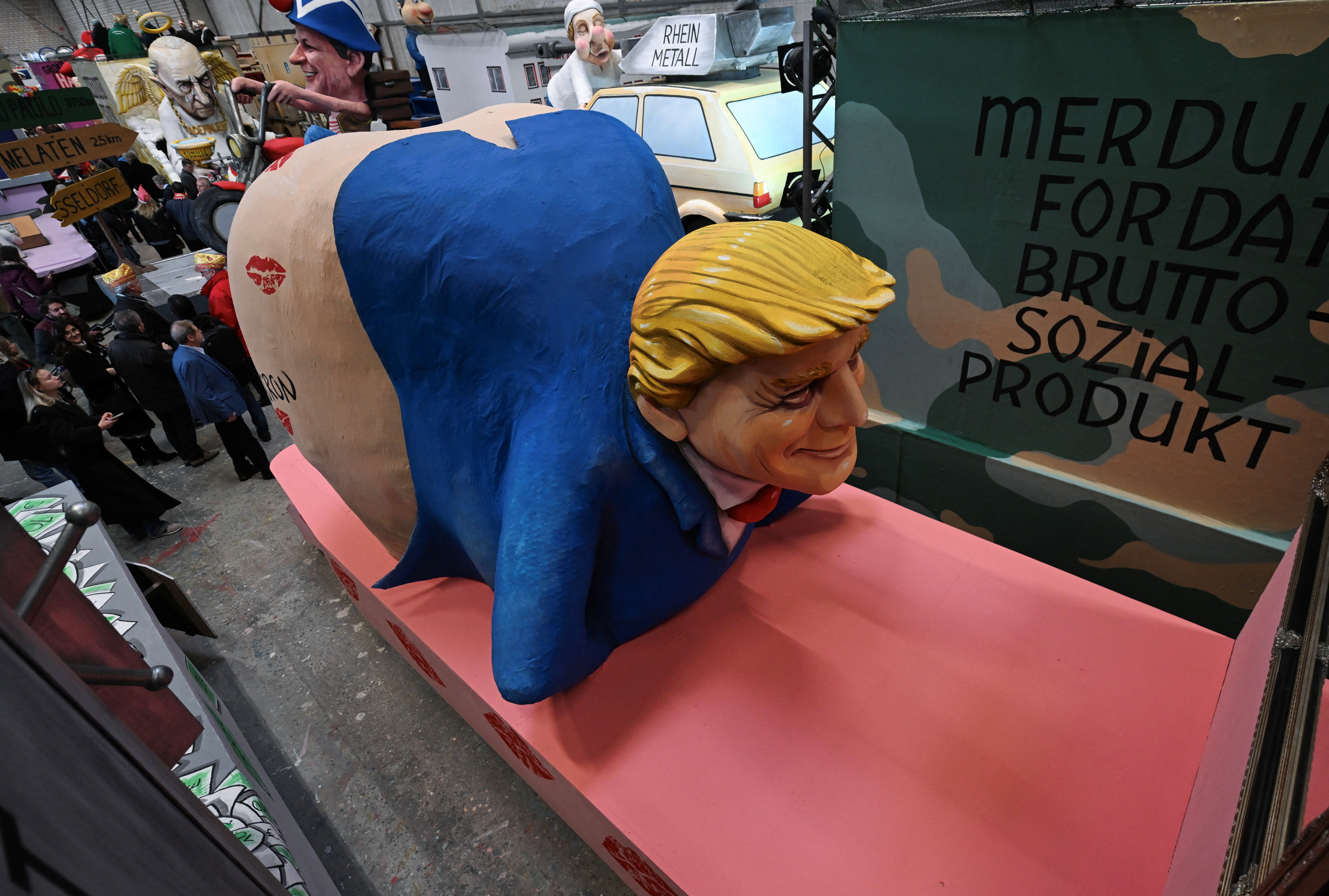 A second carnival float in Cologne, Germany, depicts Trump with no pants, with a series of kiss marks on his rear