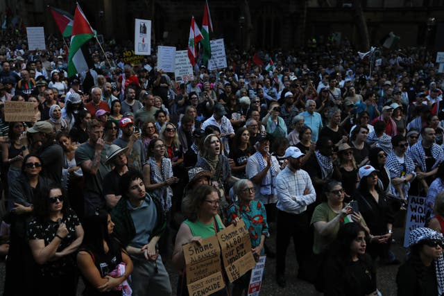 <p>People hold placards and wave Palestinian flags during a protest against the visit of Israel's president Isaac Herzog on 9 February 2026 in Sydney, Australia</p>