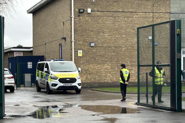 <p>A police vehicle and security guards at Kingsbury High School, north west London, where two boys, aged 12 and 13, were stabbed </p>