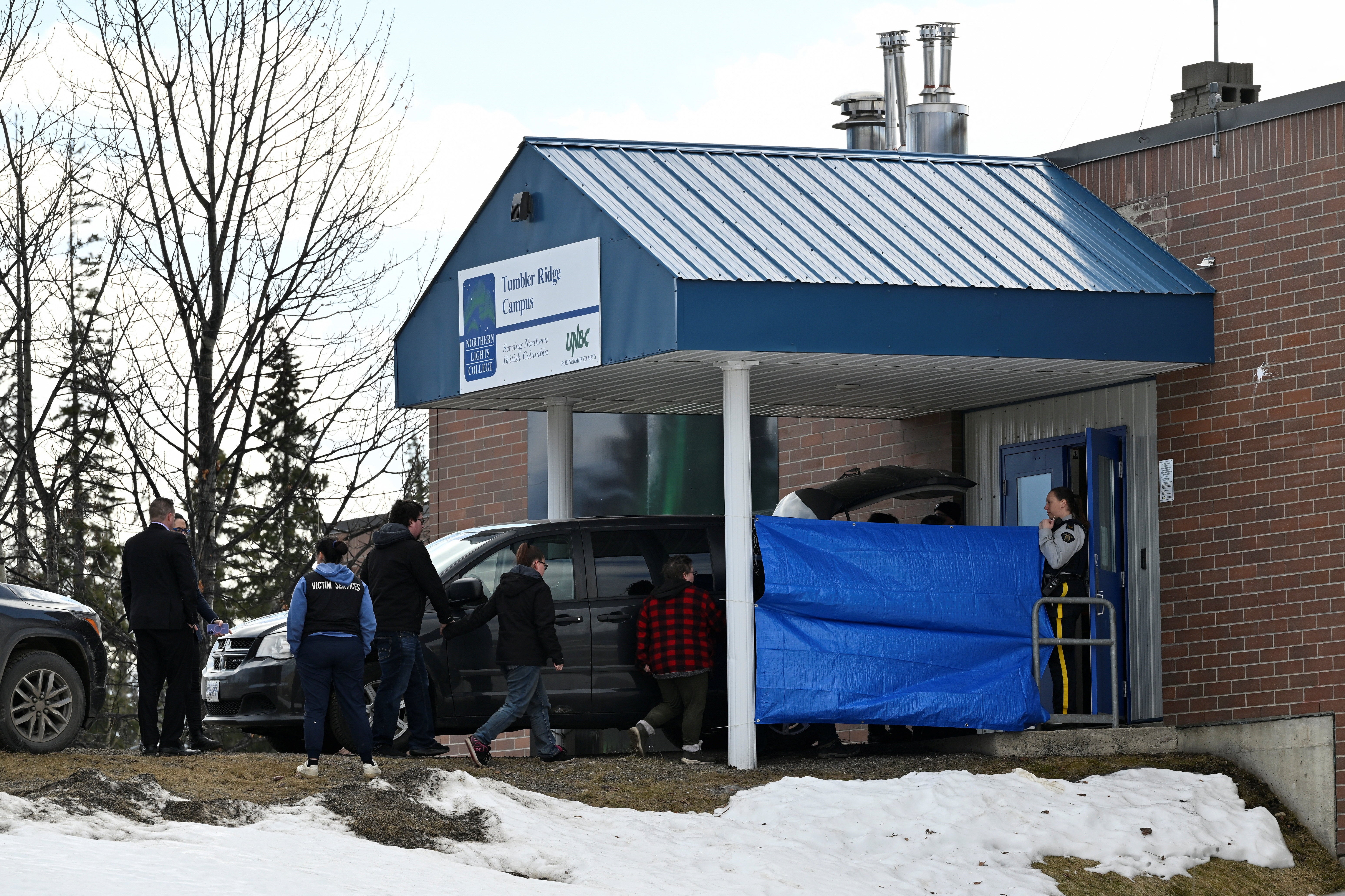 Authorities work at the high school where a deadly mass shooting took place, in the town of Tumbler Ridge