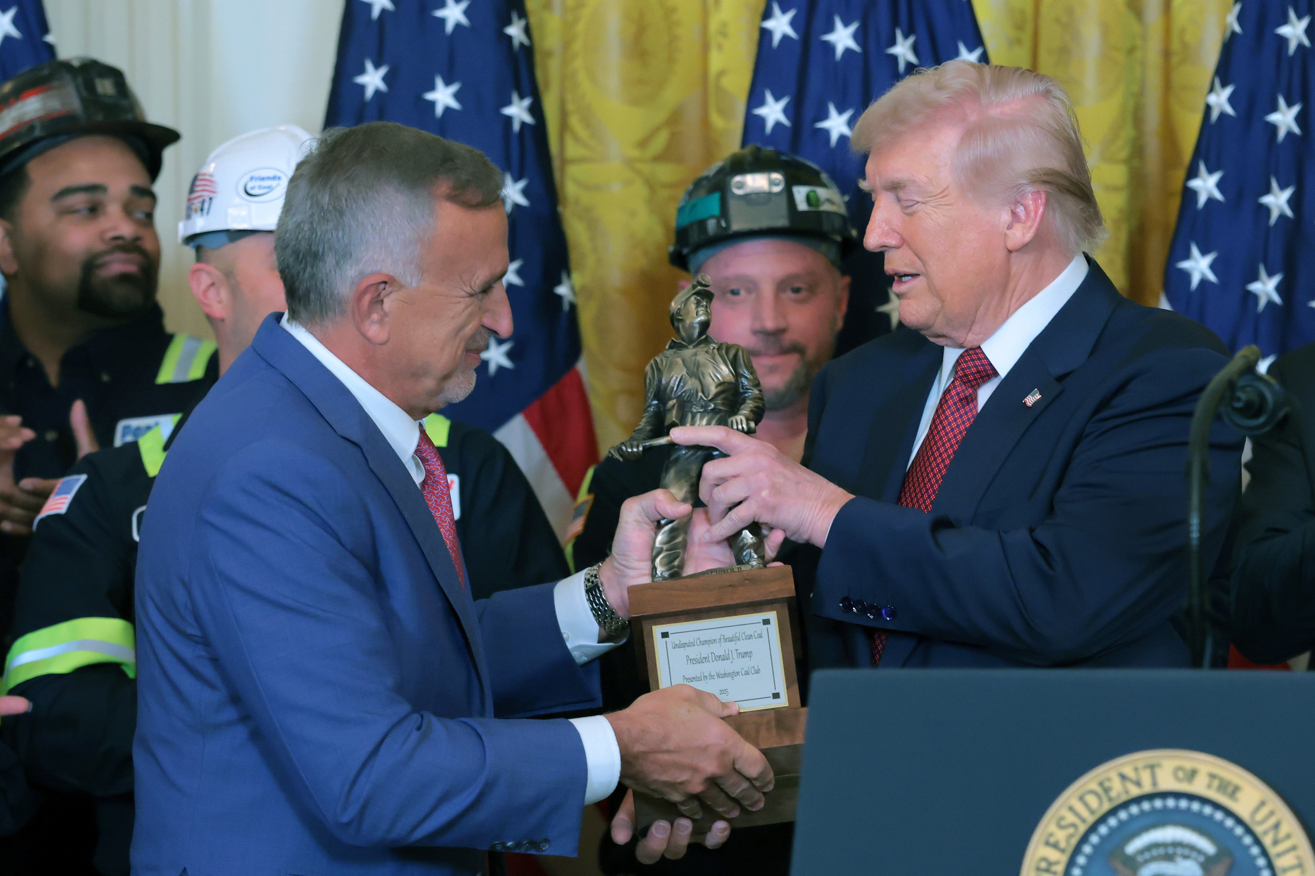 The award was handed over by President and CEO of Peabody Energy Jim Grech while more than a dozen coal executives and miners in hard hats – members of the Washington Coal Club – looked on
