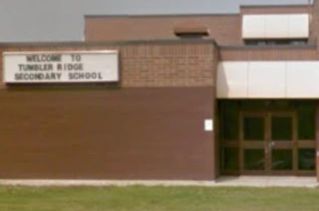 <p>Vehicles are parked outside the Tumbler Ridge Secondary School, the site of a deadly mass shooting in Tumbler Ridge, British Columbia, Canada</p>