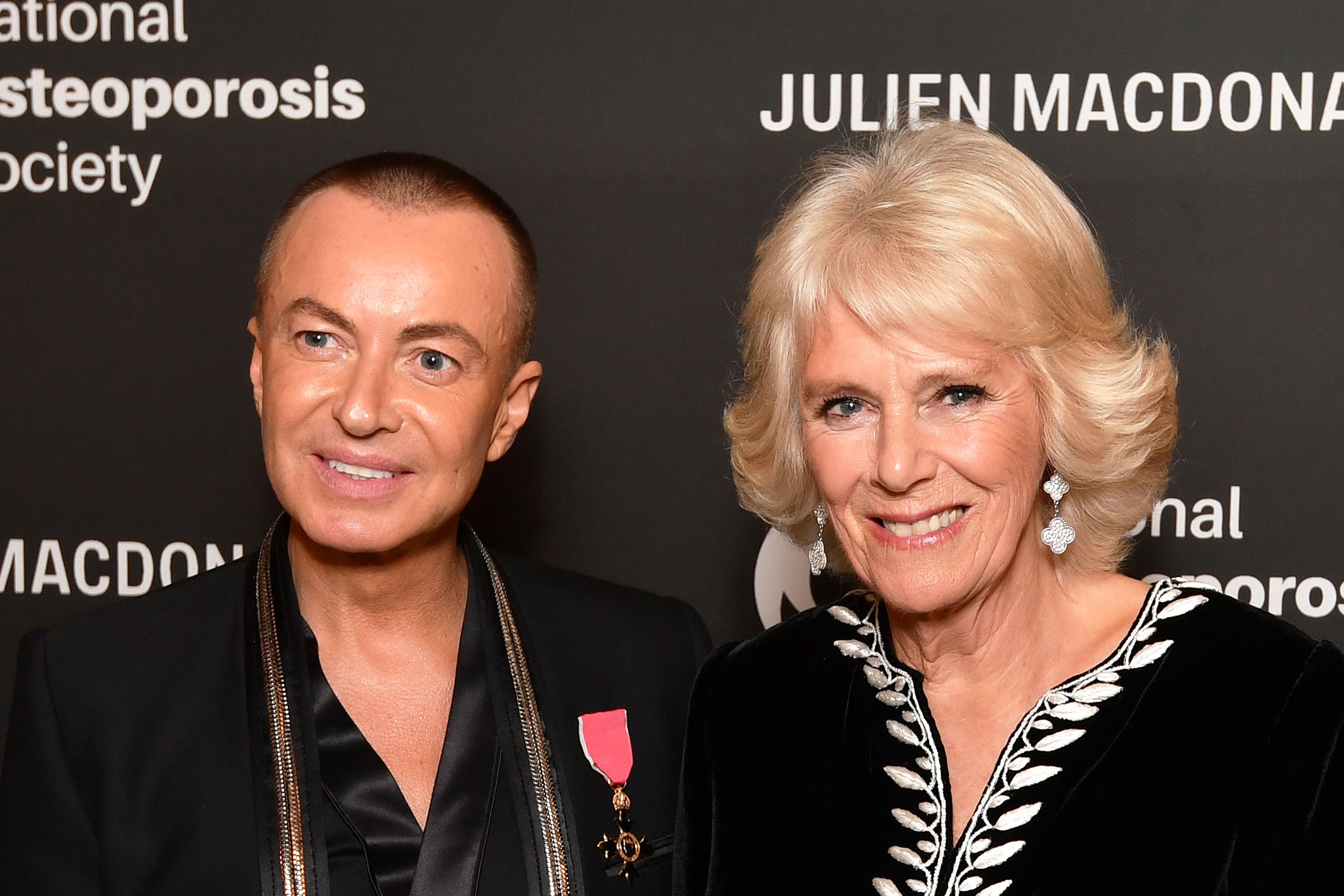 Julien Macdonald – pictured here with Queen Camilla – is returning to the London Fashion Week schedule (John Stillwell/PA)