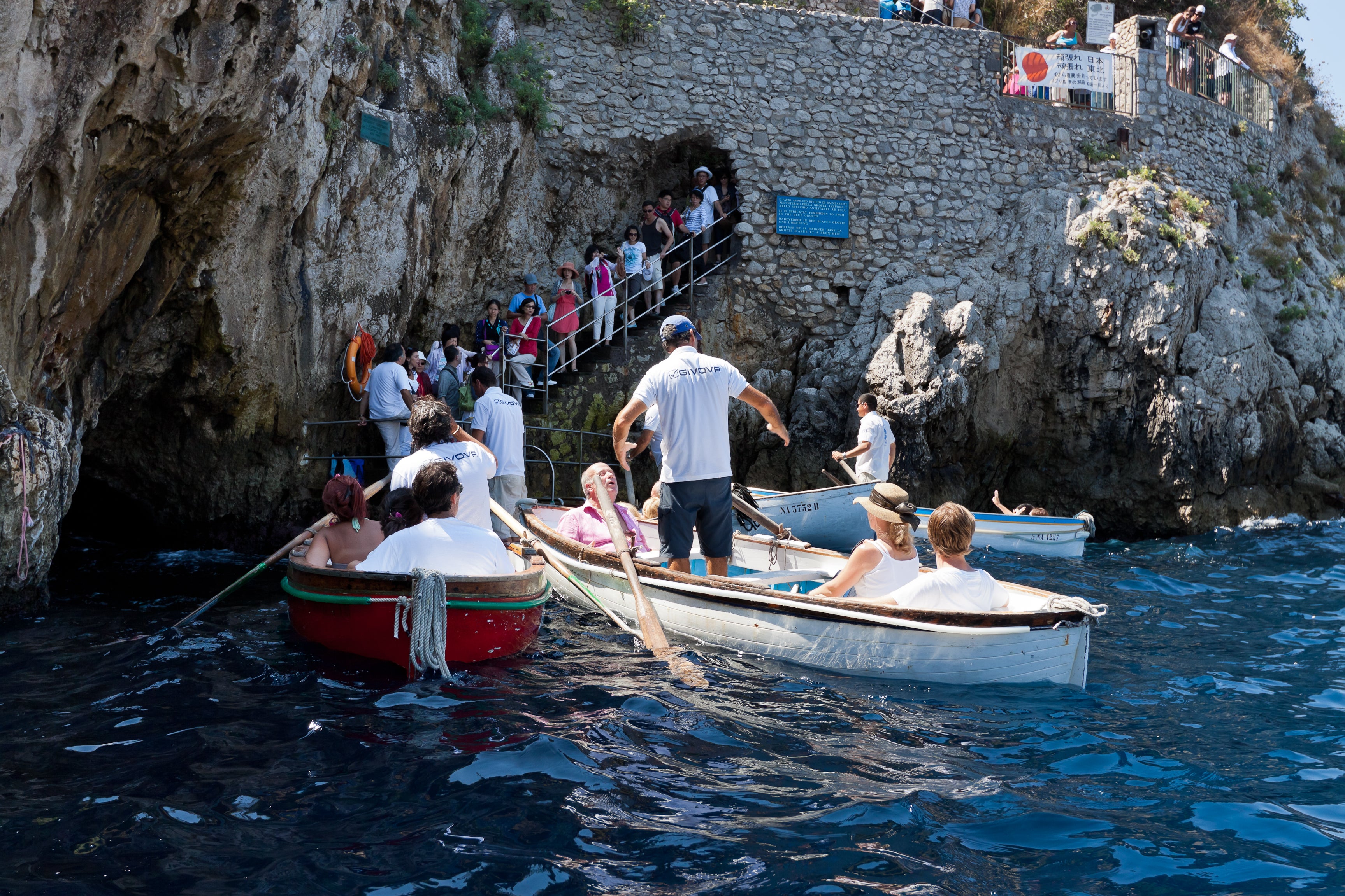 <p>Tourists on board of the small boats waiting to enter the in the famous Blue Grotto of Capri in 2011</p>