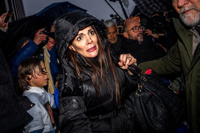 <p>Jessica Moretti, one of the owners of the bar, appears visibly moved by grieving relatives outside the prosecutor’s office on Thursday</p>