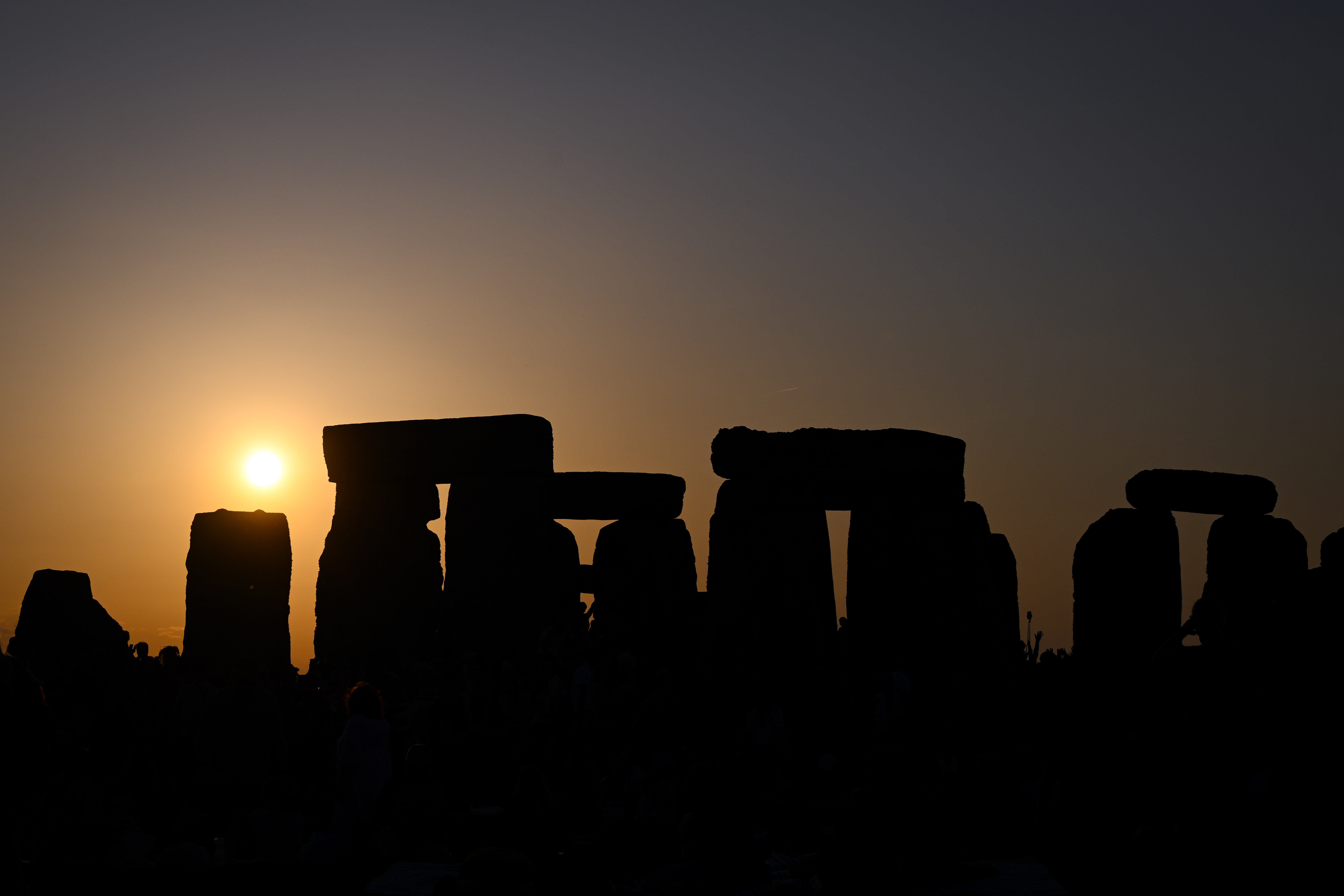 <p>The sun sets at Stonehenge during celebrations of the summer solstice</p>