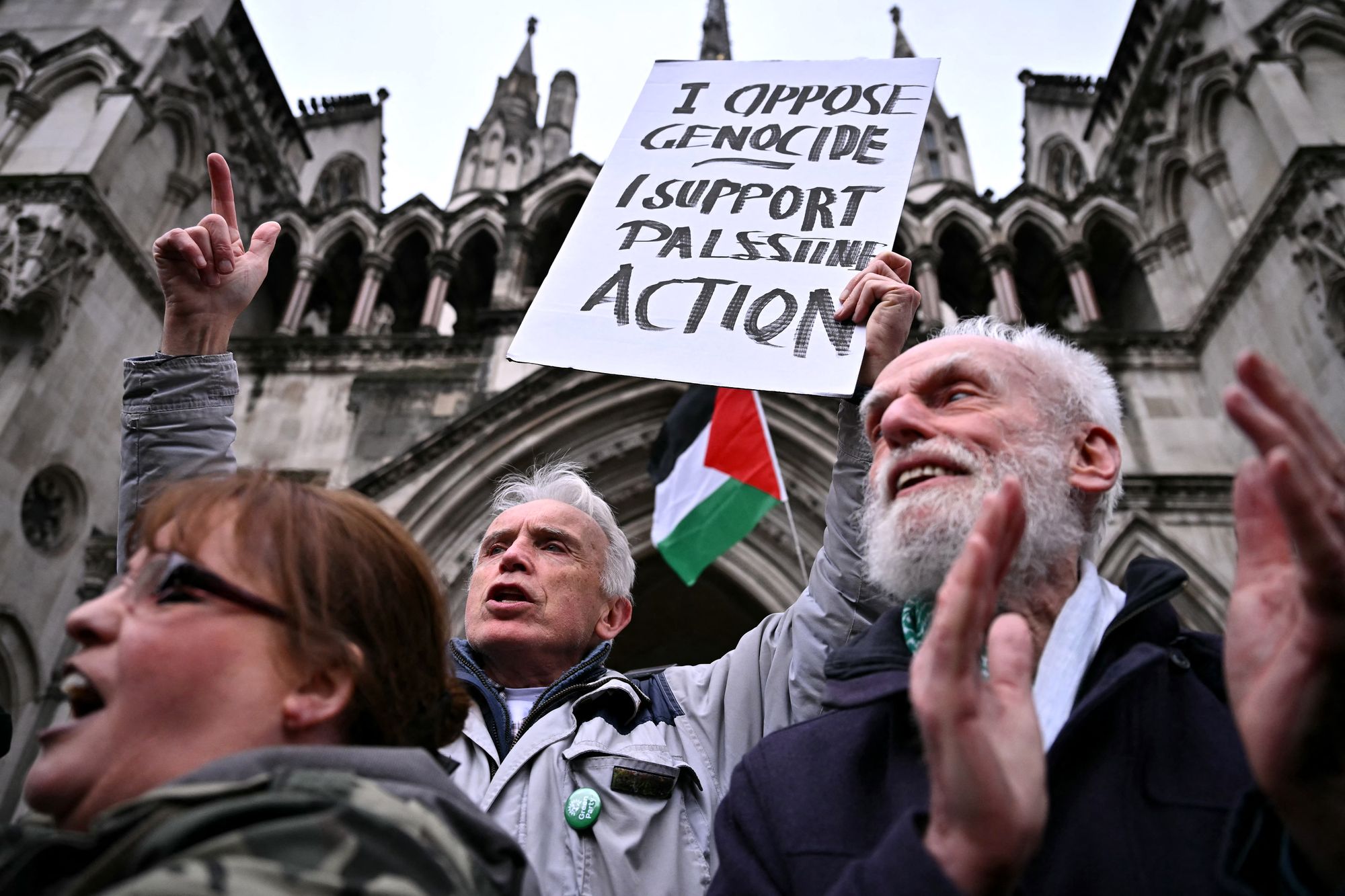 Protesters react after hearing the verdict outside the Royal Courts of Justice, Britain's High Court, in London on February 13, 2026