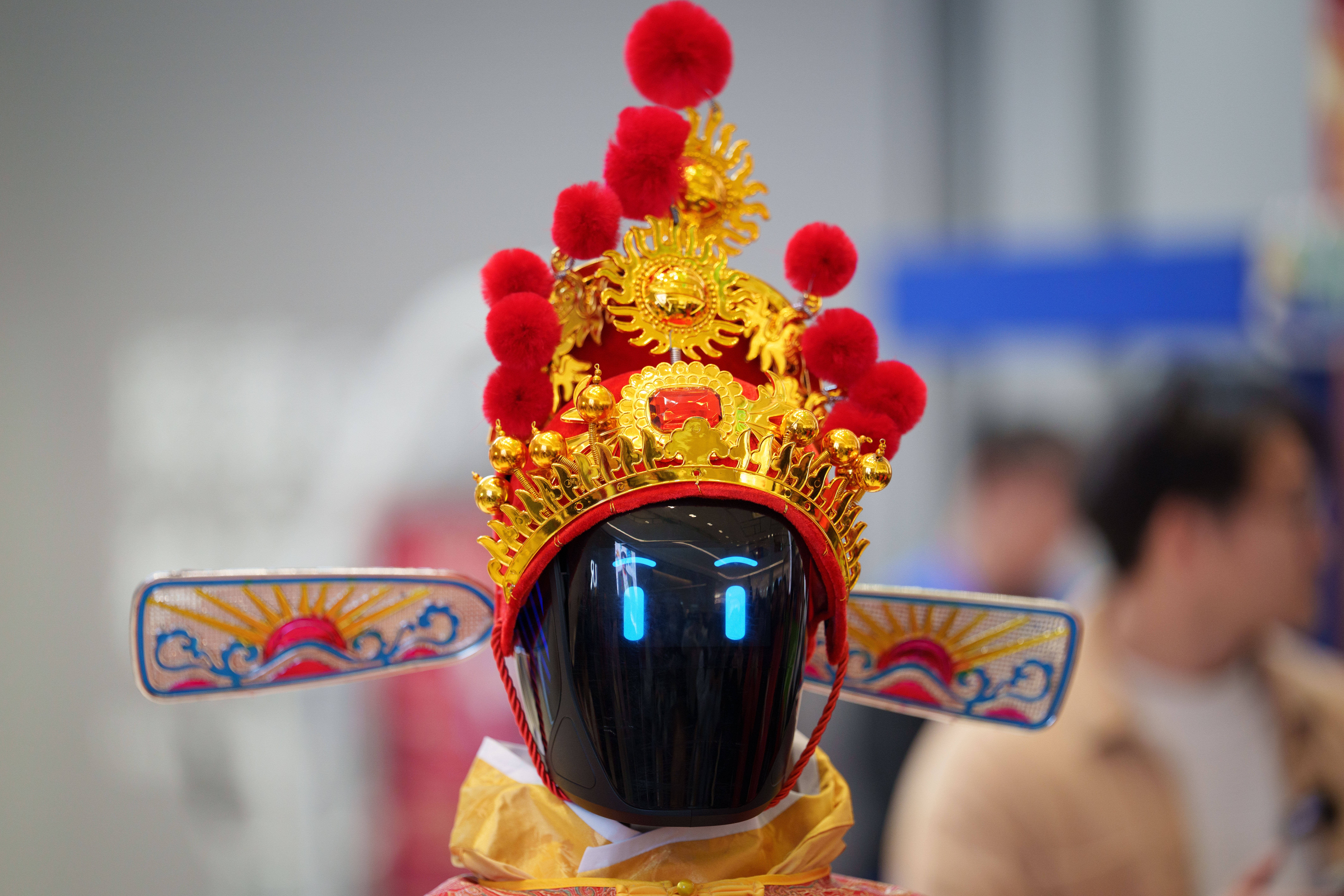 A humanoid robot wearing a traditional headdress at a robotic temple fair ahead of Lunar New Year
