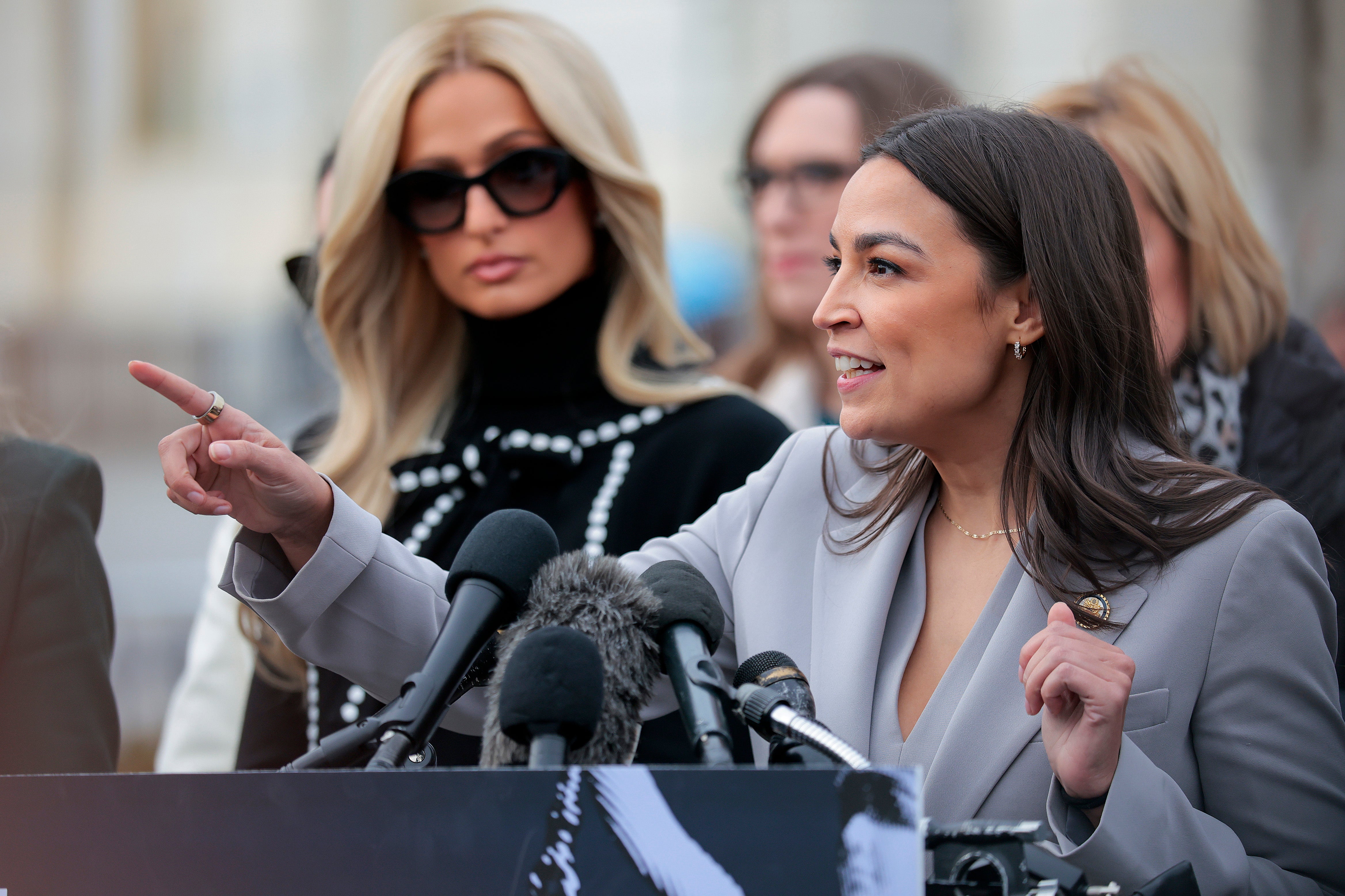 Paris Hilton listens as Rep. Alexandria Ocasio-Cortez (D-NY) speaks in support of the DEFIANCE Act at the Capitol last months. AOC has been steadily raising her profile in the Democratic Party after distinguishing herself from the more far-left Squad.