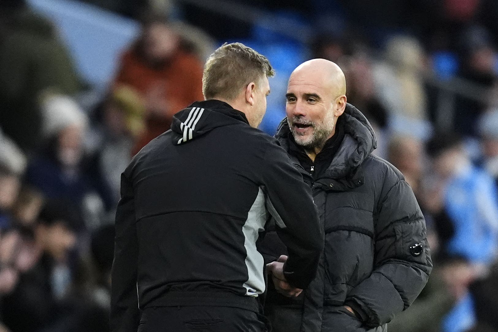 Manchester City manager Pep Guardiola, right, shakes hands with Salford City manager Karl Robinson (Nick Potts/PA)