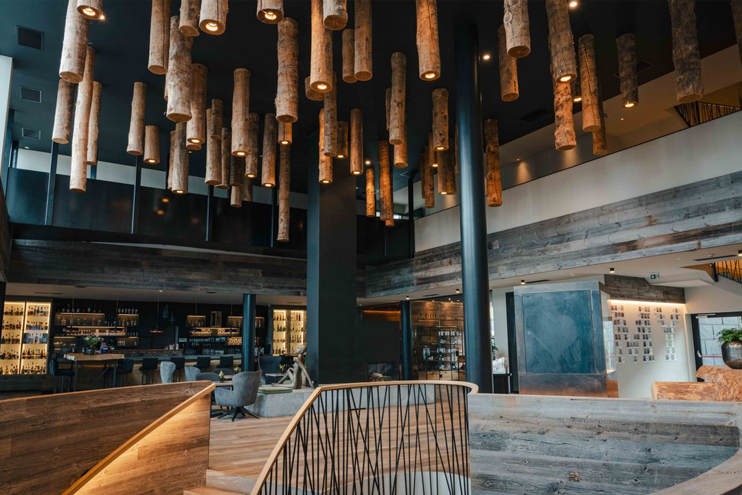 The reception and lounge feature a tree trunk installation on the ceiling