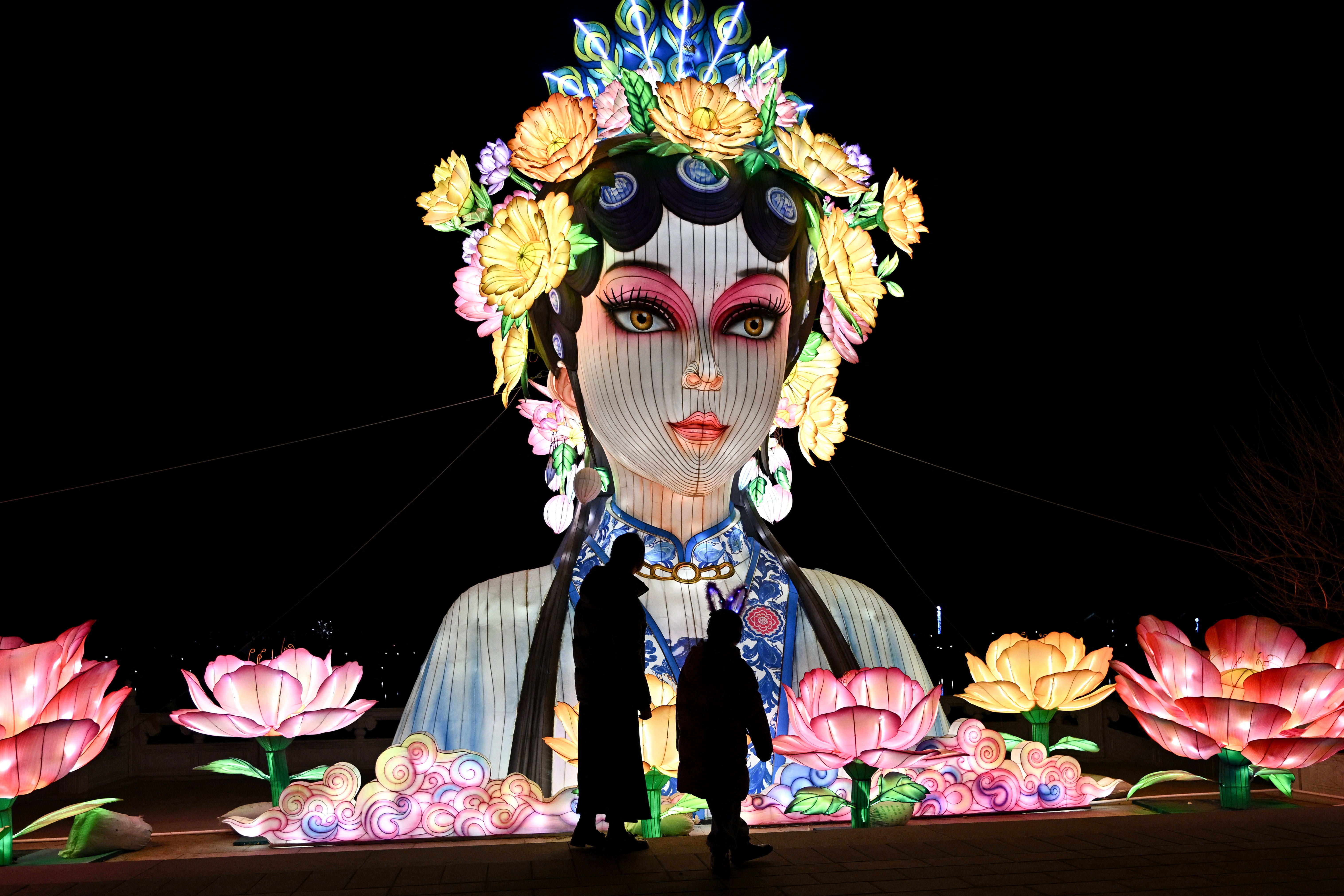 People visit a park in Beijing ahead of the Lunar New Year of the Horse.