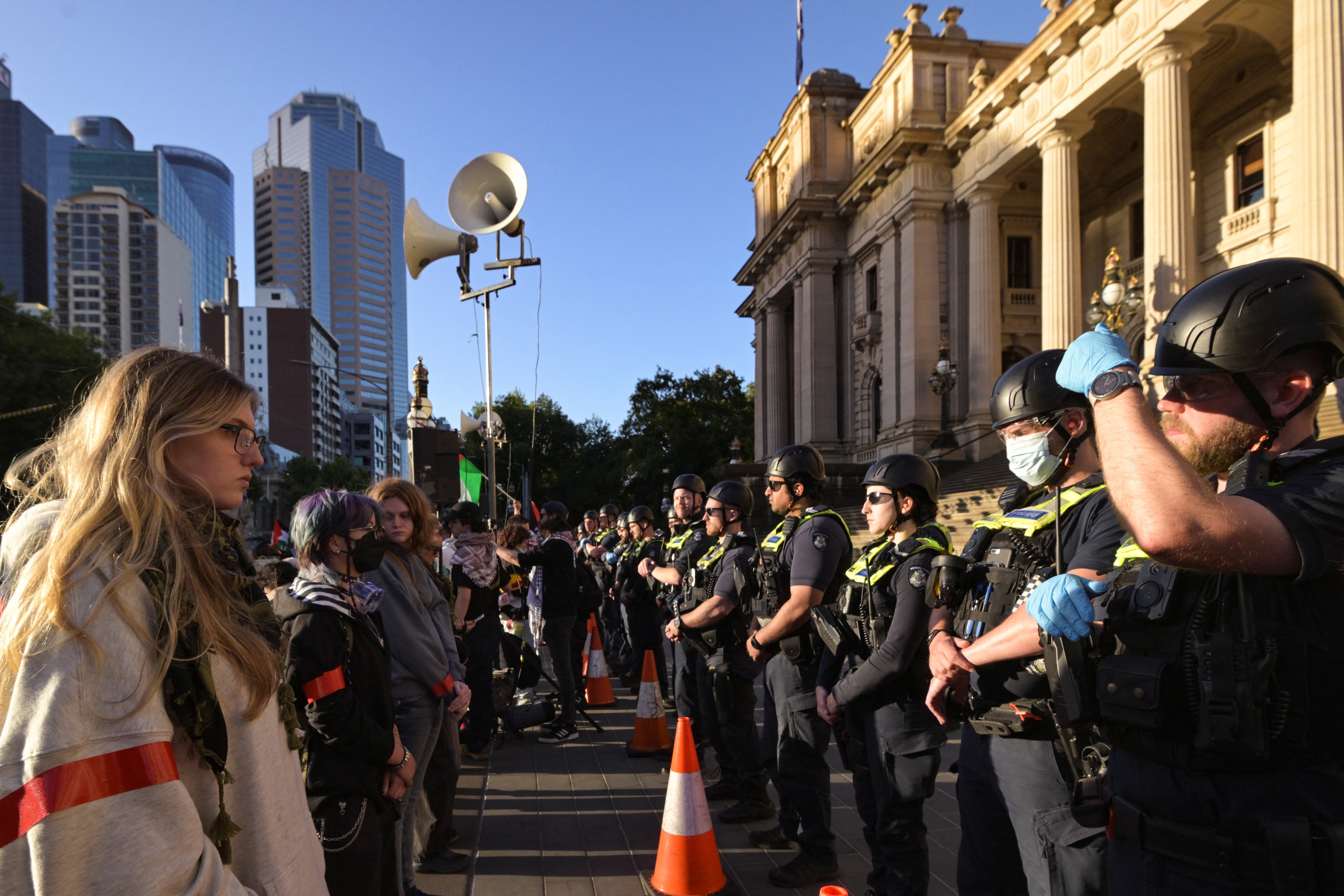 Protesters face off against police officers during a rally against the visit of Israel’s president to Australia