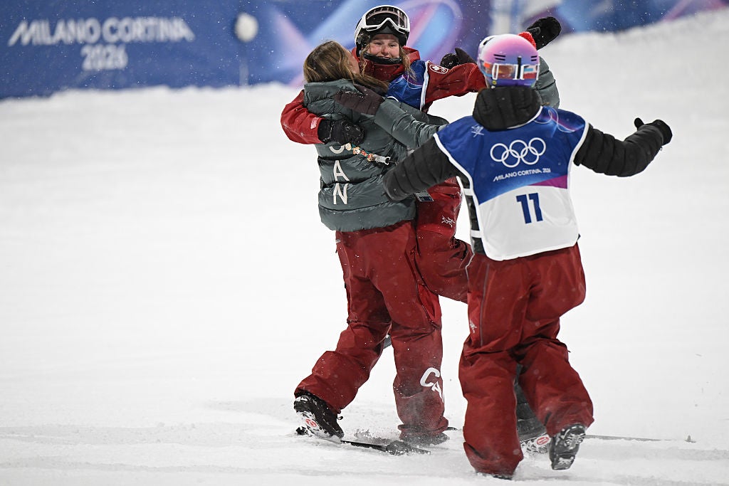 Gold medallist Megan Oldham was swarmed by teammates after her victory lap