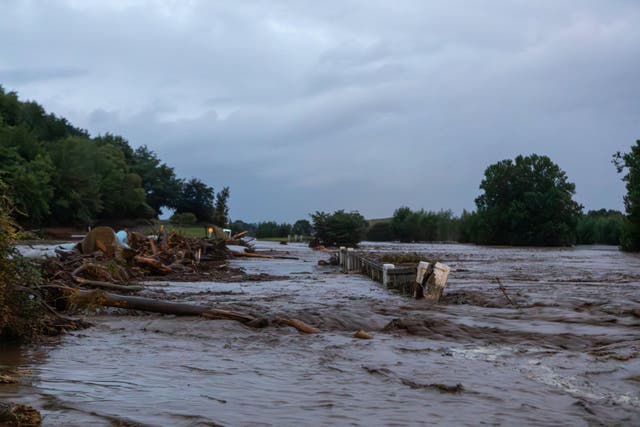 <p>Floodwaters cover the road after heavy rain and wild winds in Puketotara, Waikato region, New Zealand, 13 February 2026, in this picture obtained from social media</p>