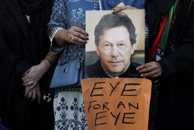 <p>Supporters of jailed former Prime Minister Imran Khan's Pakistan Tehreek-e-Insaf (PTI) party carry a poster of him during a protest over concerns about their leader's health in Karachi, Pakistan</p>
