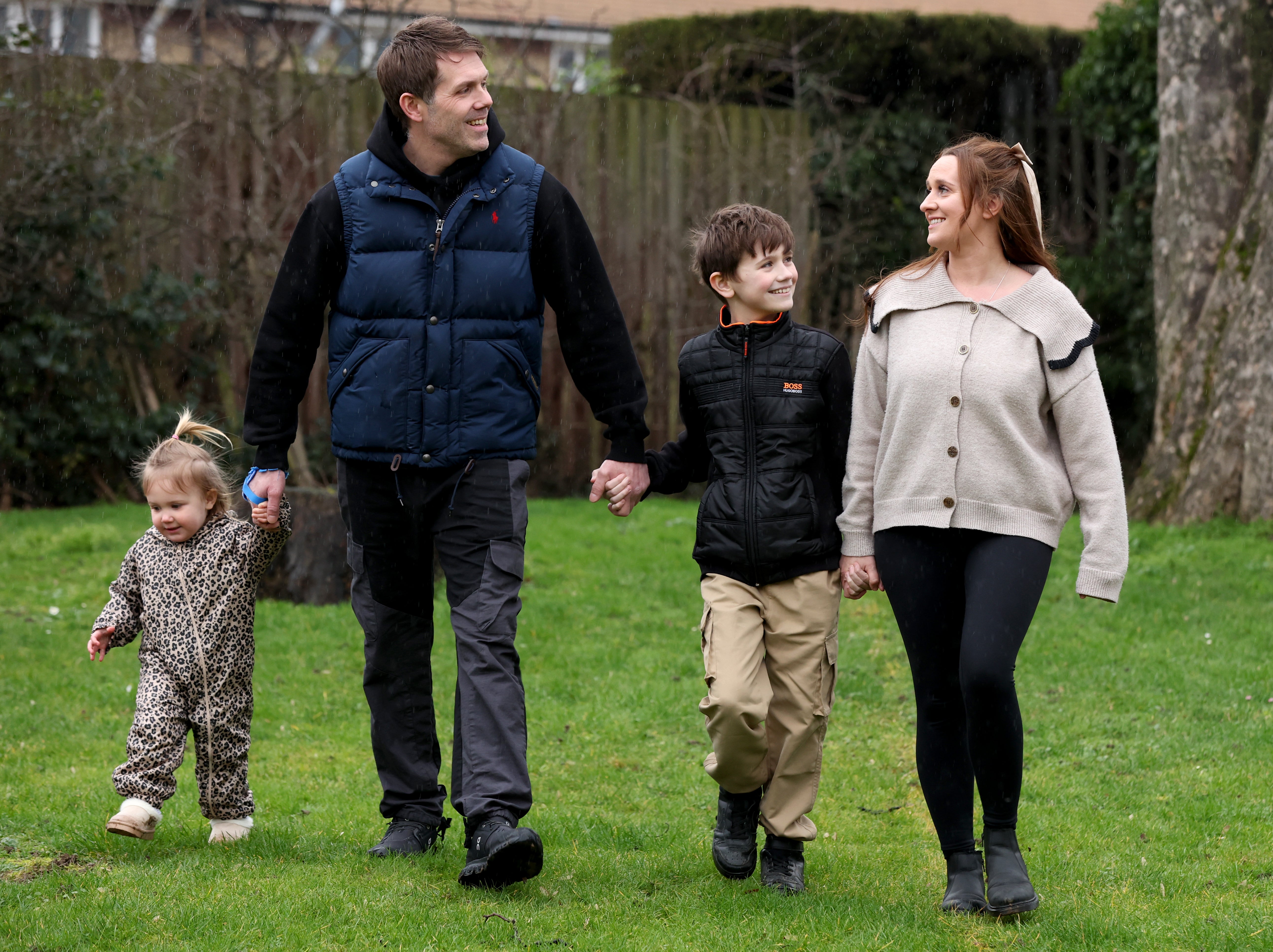 CHECK TOPIC AND KEYWORDEmbargoed to 0001 Wednesday January 28Alfie Phillips with his mother Laura Ducker and her partner Scot Phillips and sister Matilda at their home near Northampton. Surgeons at Alder Hey have pioneered a new technique to lengthen the leg of the nine-year-old born with an ultra-rare condition which left one leg 4cm shorter than the other. The procedure was a UK first, they added 3cm to his leg and have since performed it on other patients, with centres round the country preparing to do the same. Picture date: Sunday January 25, 2026. PA Photo. Photo credit should read: Chris Radburn/PA Wire