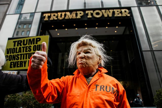 <p>A person in a costume depicting U.S. President Donald Trump in an orange jumpsuit gives a thumbs-up as demonstrators gather during a flash mob in front of Trump Tower on Presidents' Day in New York City, U.S., February 16, 2026.  </p>