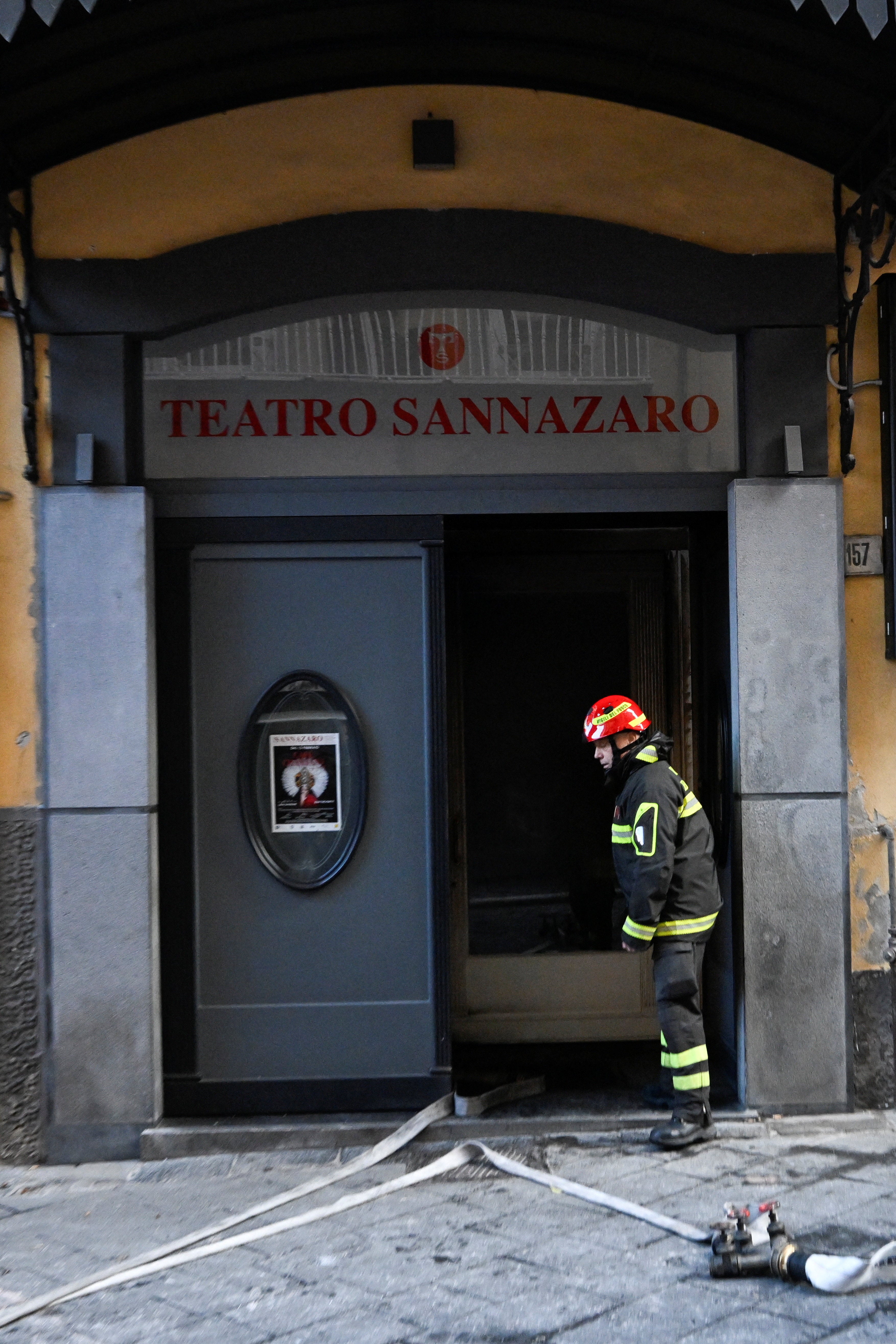A fireman at the entrance of the historic wood-framed Teatro Sannazaro damaged in a fire in Naples, Italy