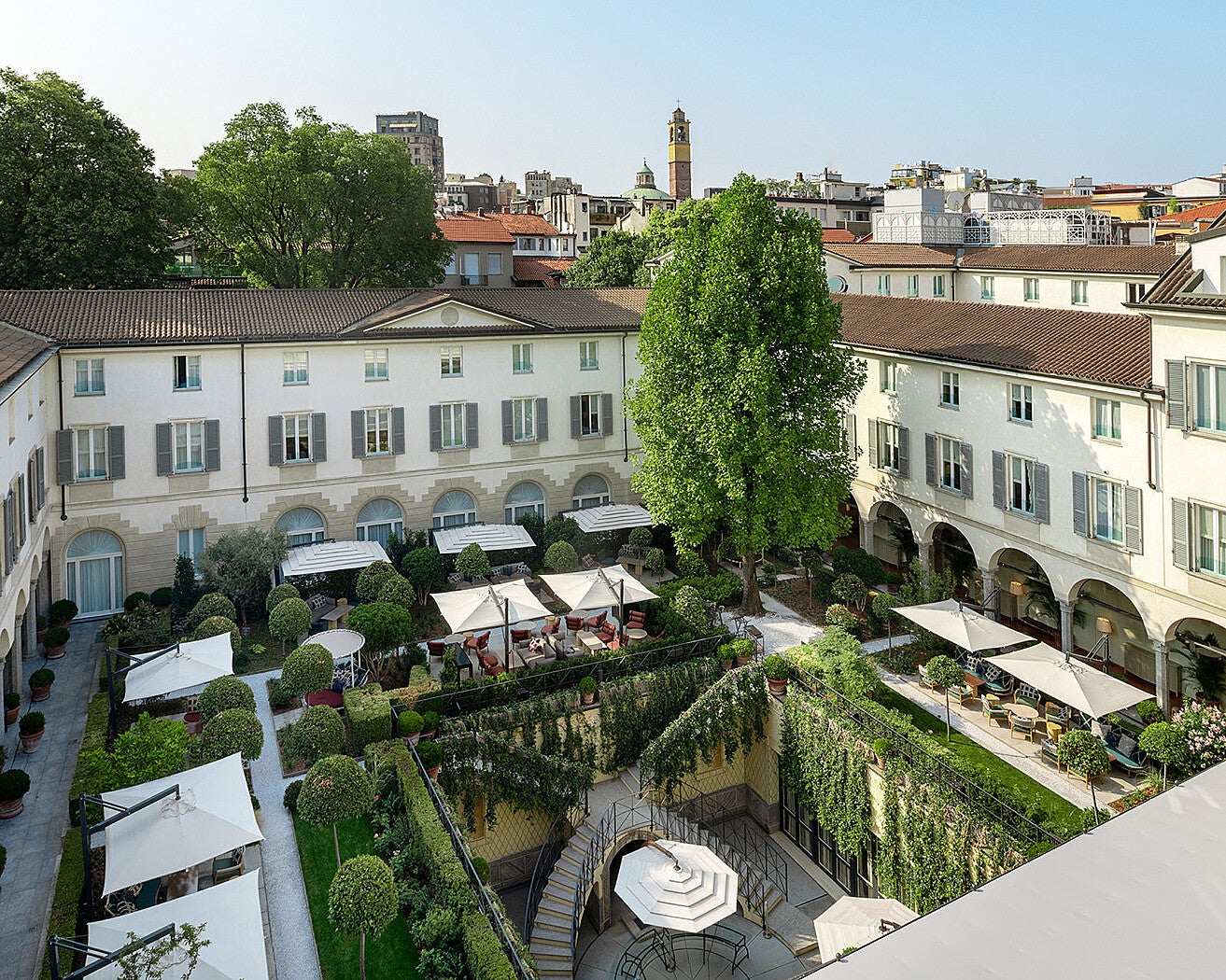 The hotel’s cloistered garden serves drinks under twinkling lights