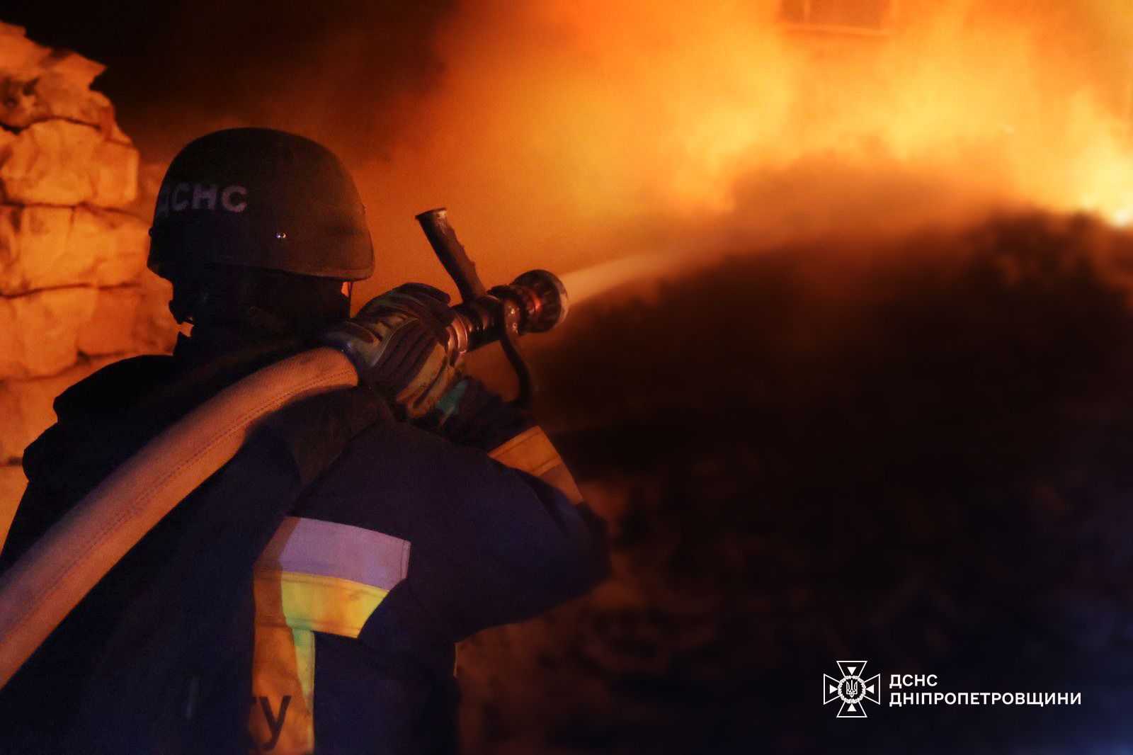 Firefighters work at the scene of overnight strikes in Ukraine