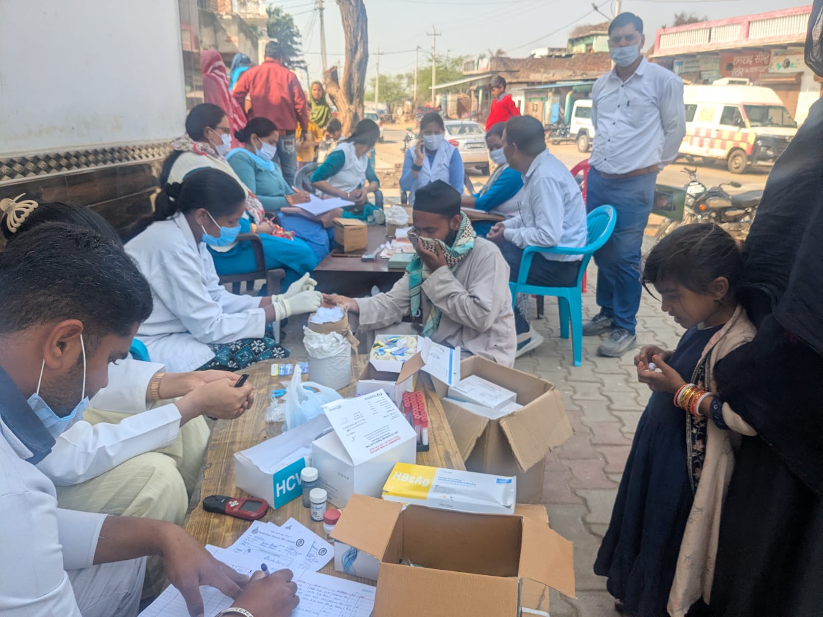 Healthcare workers screen villagers at a medical camp in Chhainsa, Haryana, India