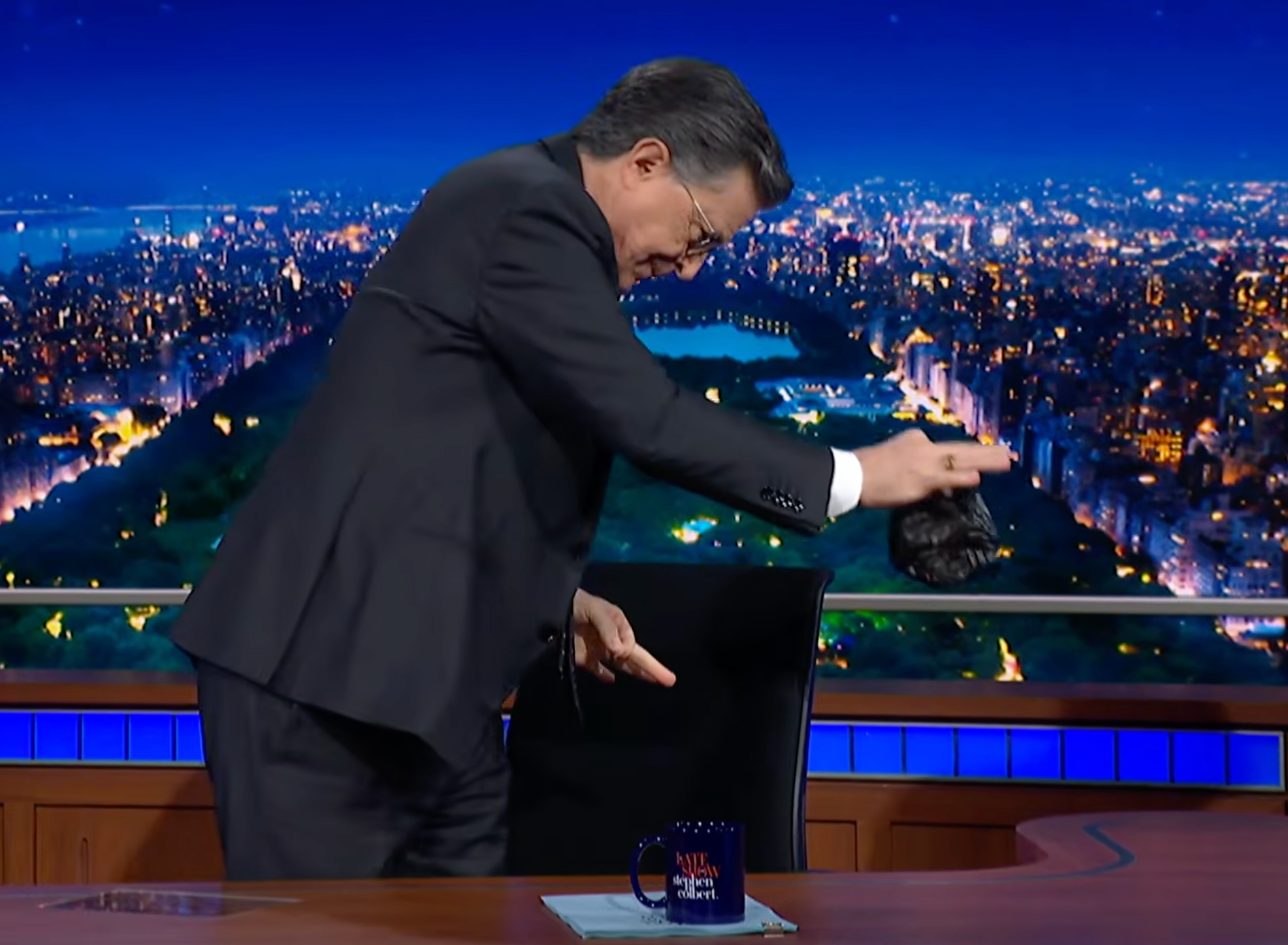Colbert drops a plastic bag containing CBS's scrunched-up statement into the trash on Tuesday's episode of The Late Show