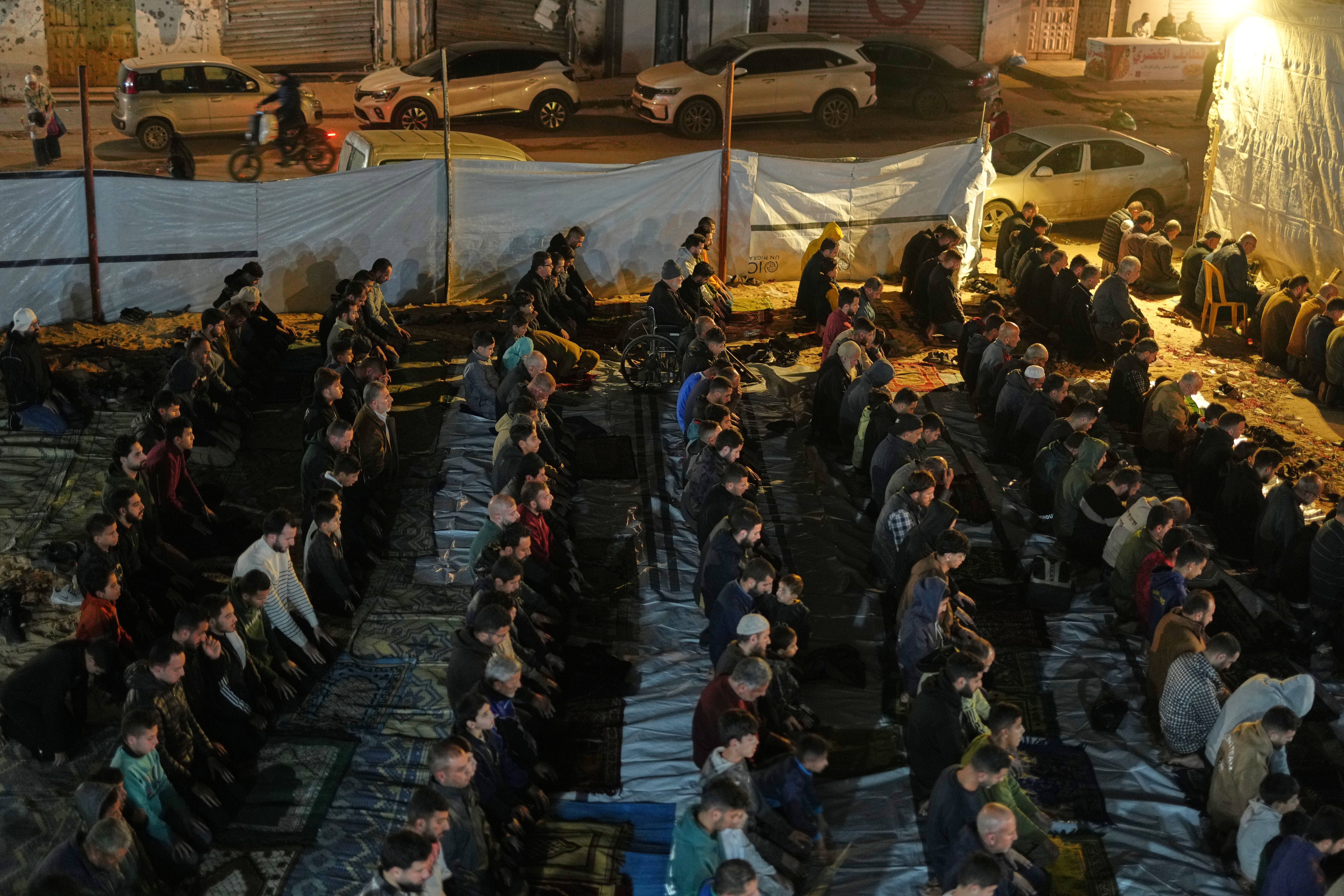 Muslim worshippers perform the evening prayer on the first night of Ramadan at the al-Kanz Mosque, damaged during the war, in Gaza City