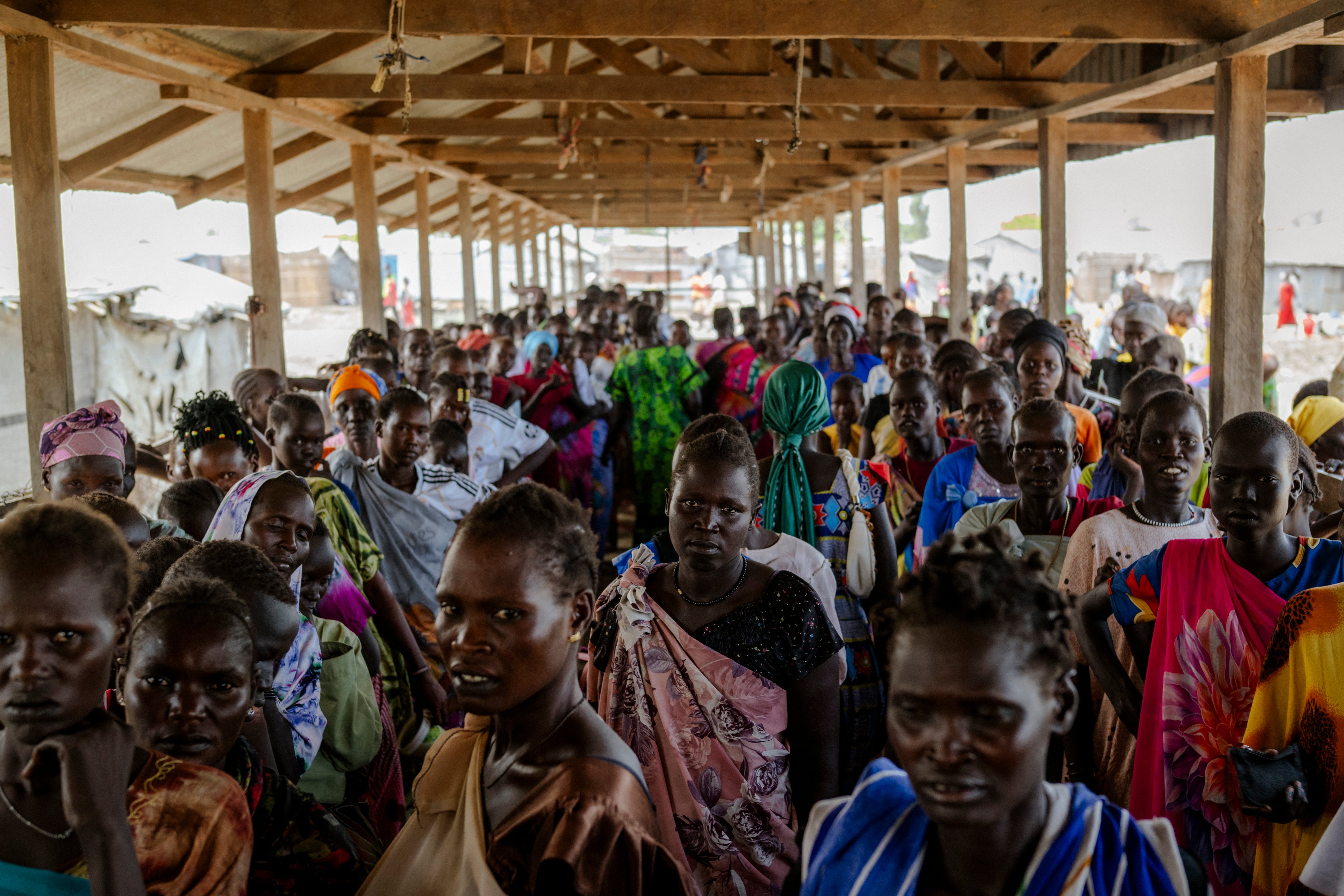 People wait for food collection at the Bentiu internally displaced persons camp in Unity State, South Sudan, The camp relies on World Food Programme (WFP) deliveries amid flooding and global aid cuts